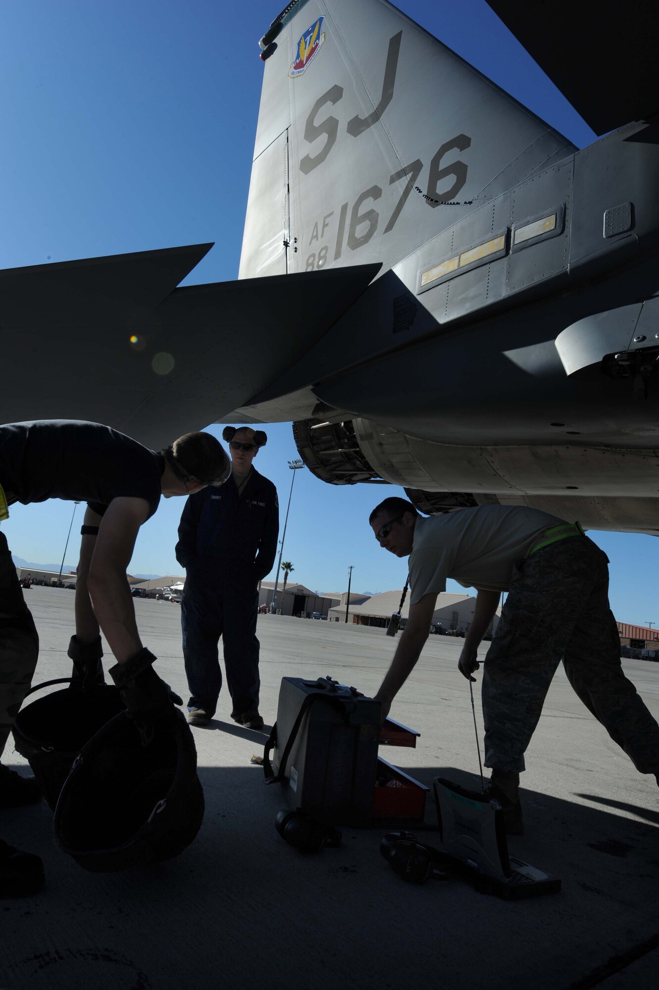 Maintainers assigned to the 4th Maintenance Group at Seymour Johnson Air Force Base, N.C., perform various maintenance tasks on an F-15E Strike Eagle during the Red Flag 09-2 exercise at Nellis AFB, Nev., Jan. 30. Red Flag is a multi-national exercise providing a realistic environment to practice combat scenarios. The experience gained during the exercise is vital to the survival of air crews in combat. (U.S. Air Force photo/Senior Airman Nadine Y. Barclay) 