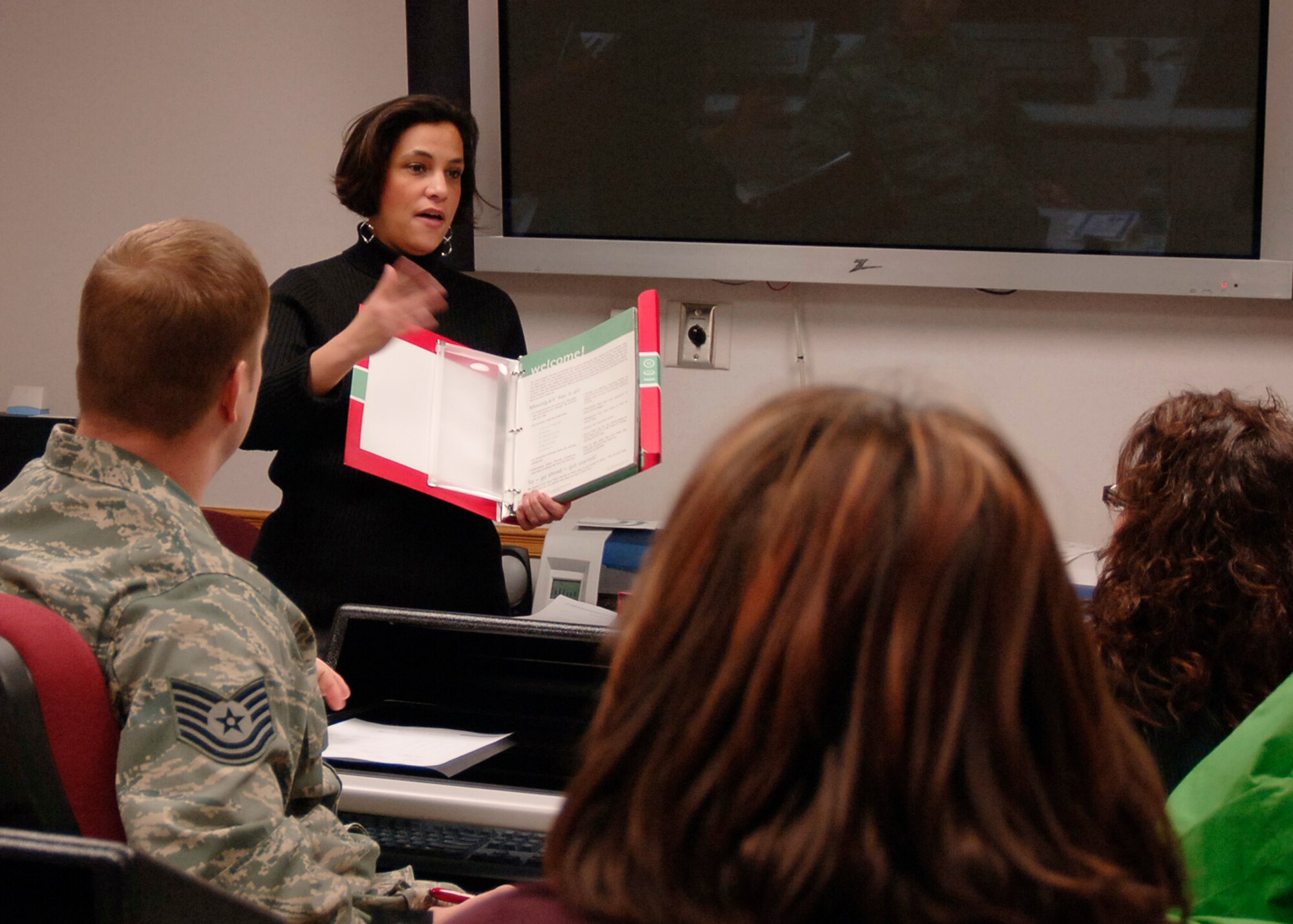 MCCONNELL AIR FORCE BASE, Kan. -- Rebecca Schlecht, 22nd Force Support Squadron, shows a moving kit to the attendees of the Smooth Move class at the Airman and Family Readiness Center, Jan. 26. The class offered briefers from the Tri-care office, housing and Transportation Management Offices a chance to help Team McConnell members with transitions to new bases. (Photo by Airman 1st Class Maria Ruiz)