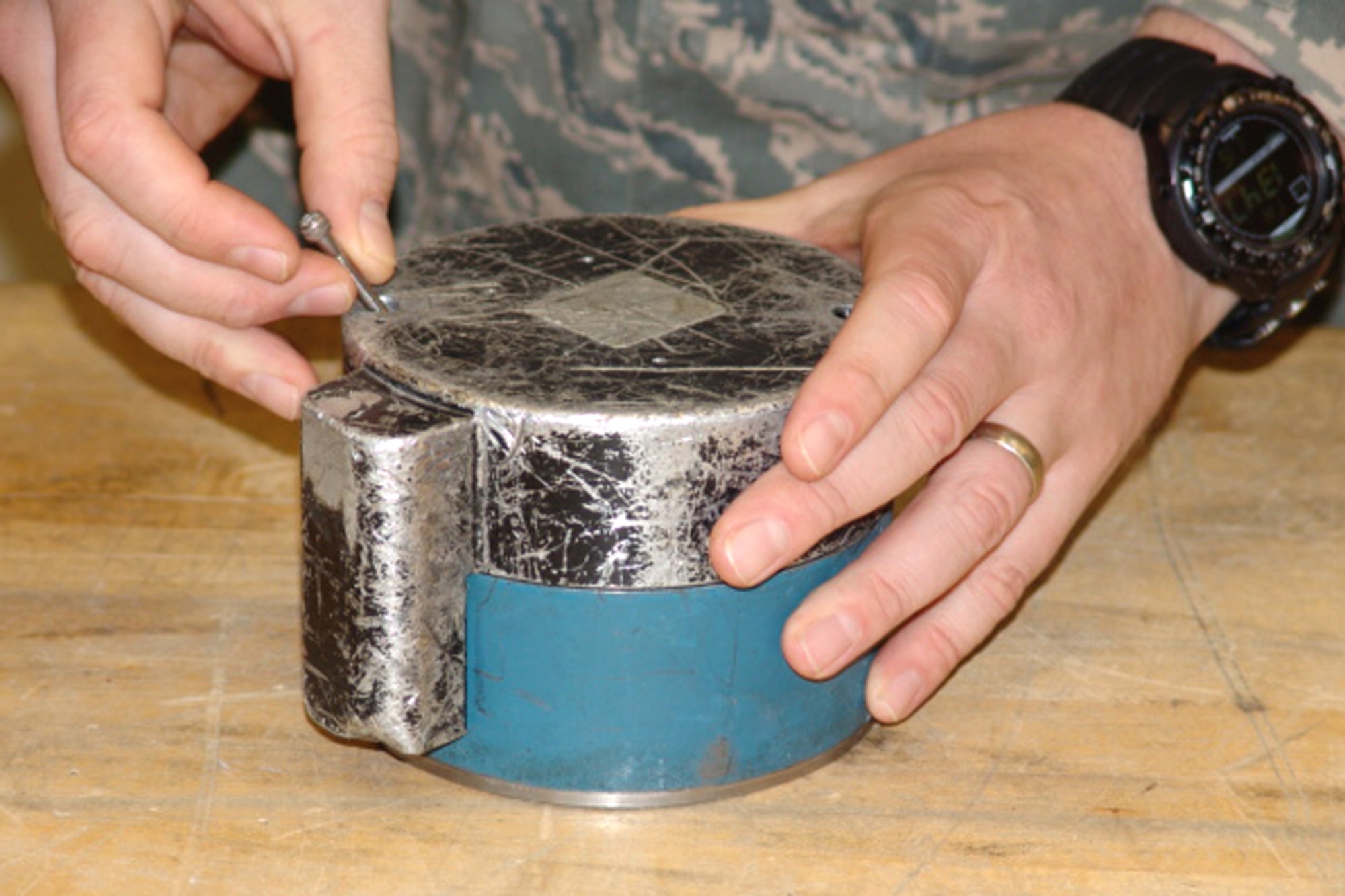 EGLIN AIR FORCE BASE, Fla. Explosive Ordnance Disposal  robots of the 96th Civil Engineer Group EOD Flight must be able to manipulate small screws, like this one shown on a warhead of a submunition. The flight has adapted tools in order to accommodate their mission.  (U.S. Air Force photo by Noel Getlin)                         