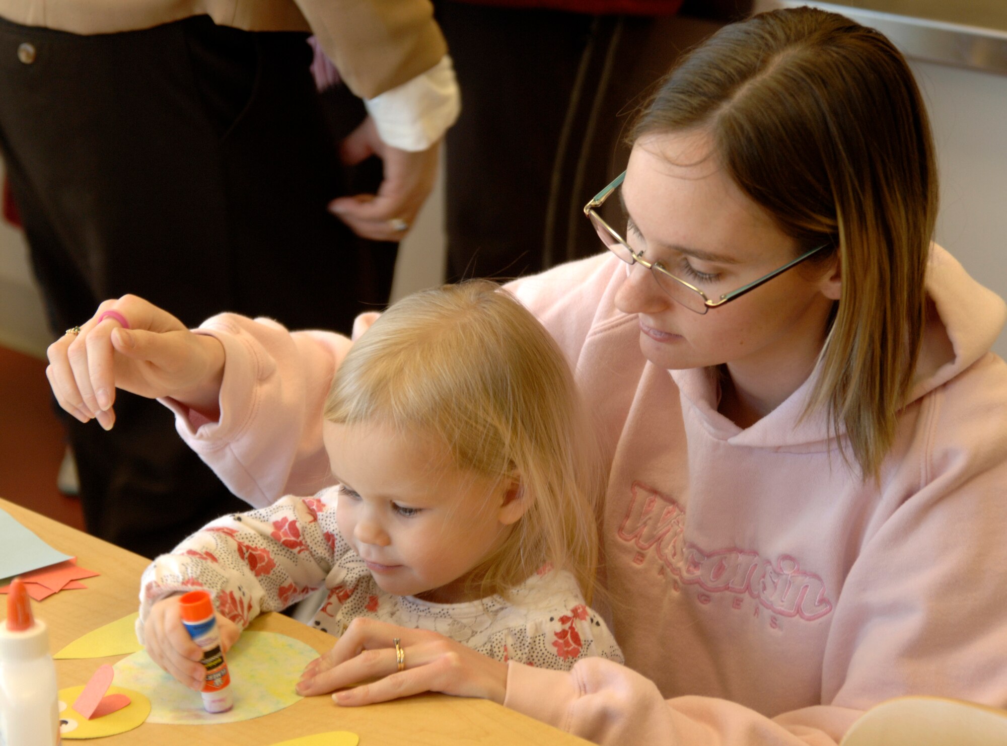 MCCONNELL AIR FORCE BASE, Kan. --  Team McConnell members, Sara Bruno and her daughter, Gracie, 3, participate in arts-and-crafts during the Cookie Bookie held at the School Age Program, Feb. 3. The Cookie Bookie is held every first Tuesday of every month. To participate in the Cookie Bookie program, call 759-6859. (Photo by Senior Airman Laura Suttles)