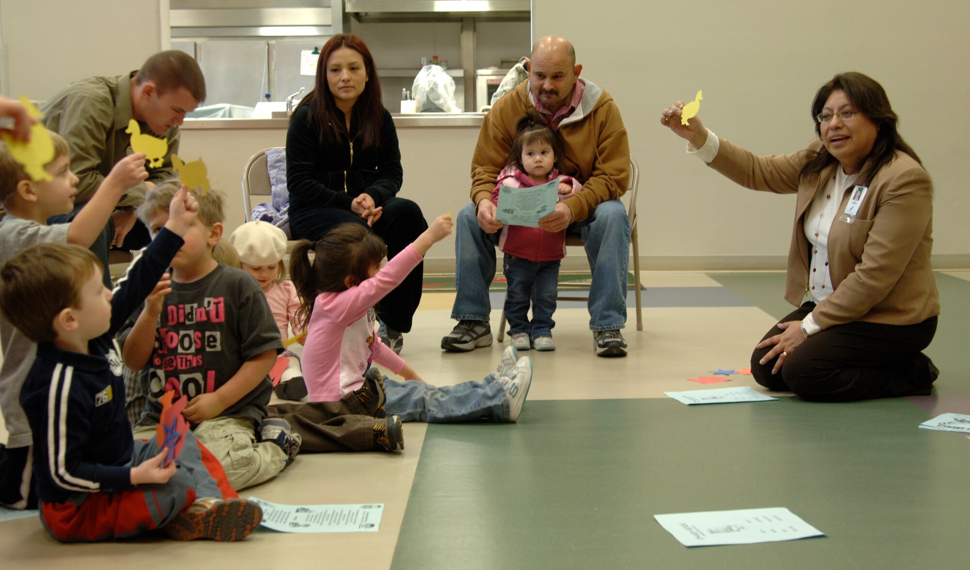 MCCONNELL AIR FORCE BASE, Kan. -- Sandy Gherardini, Outreach and Special Projects Coordinator for Derby Schools District, teaches Spanish to young Team McConnell children during the Cookie Bookie outreach program at the School Age Program, Feb. 3. The Cookie Bookie program consists of singing the Cookie Bookie song, reading to children, teaching Spanish, arts and crafts, and icing cookies. (Photo by Senior Airman Laura Suttles)