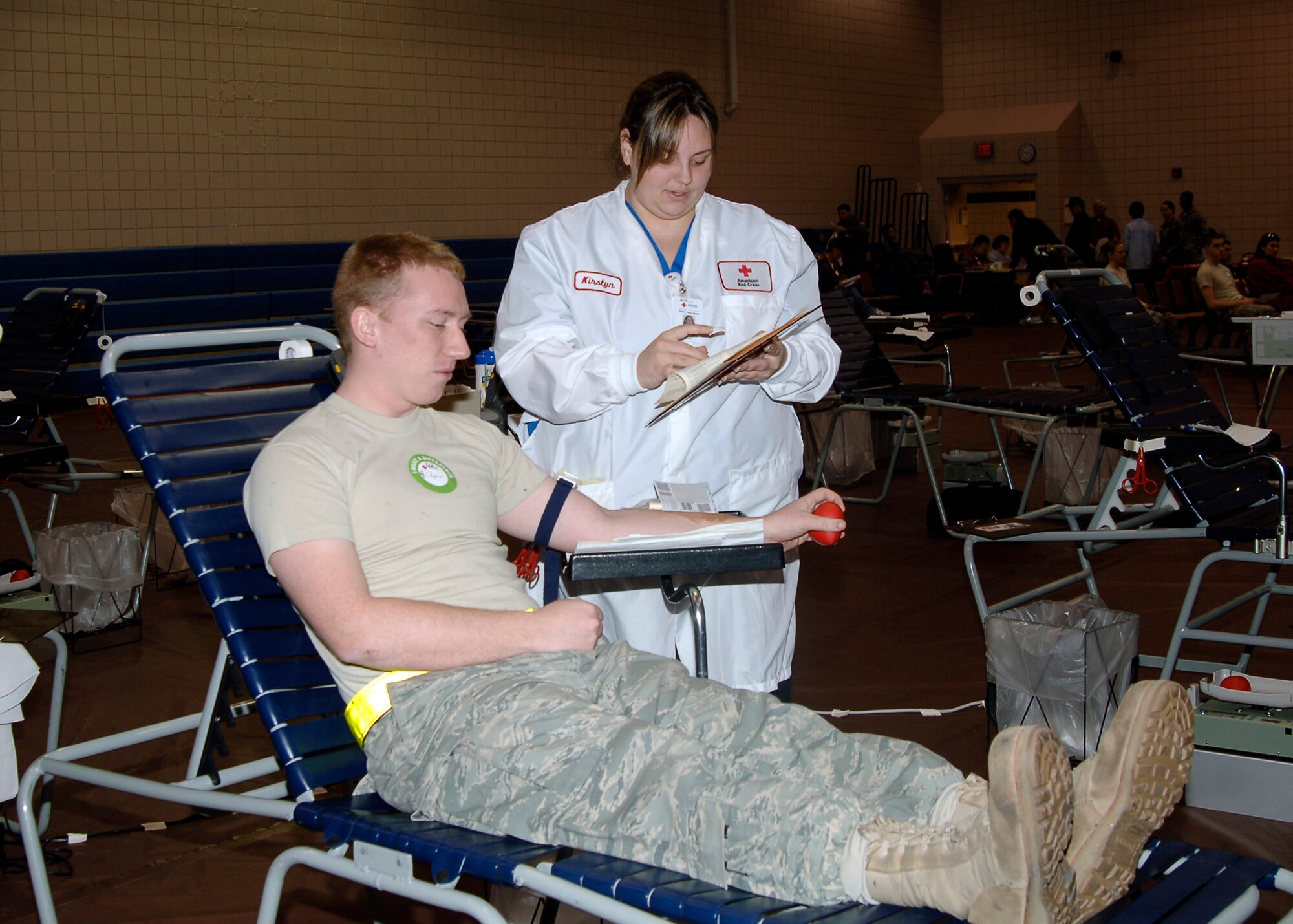 MCCONNELL AIR FORCE BASE, Kan. -- Senior Airman Jeremy Ryan, 22nd Maintenance Squadron, donates blood with the aid of Kirstyn, an American Red Cross lab technician, during the blood drive at the fitness center in the Robert J. Dole Community Center, Jan. 30. Volunteers who give blood must go through a medical check list before donating to ensure there will not be any complications donating blood. (Photo by Senior Airman Anthony Mejia)