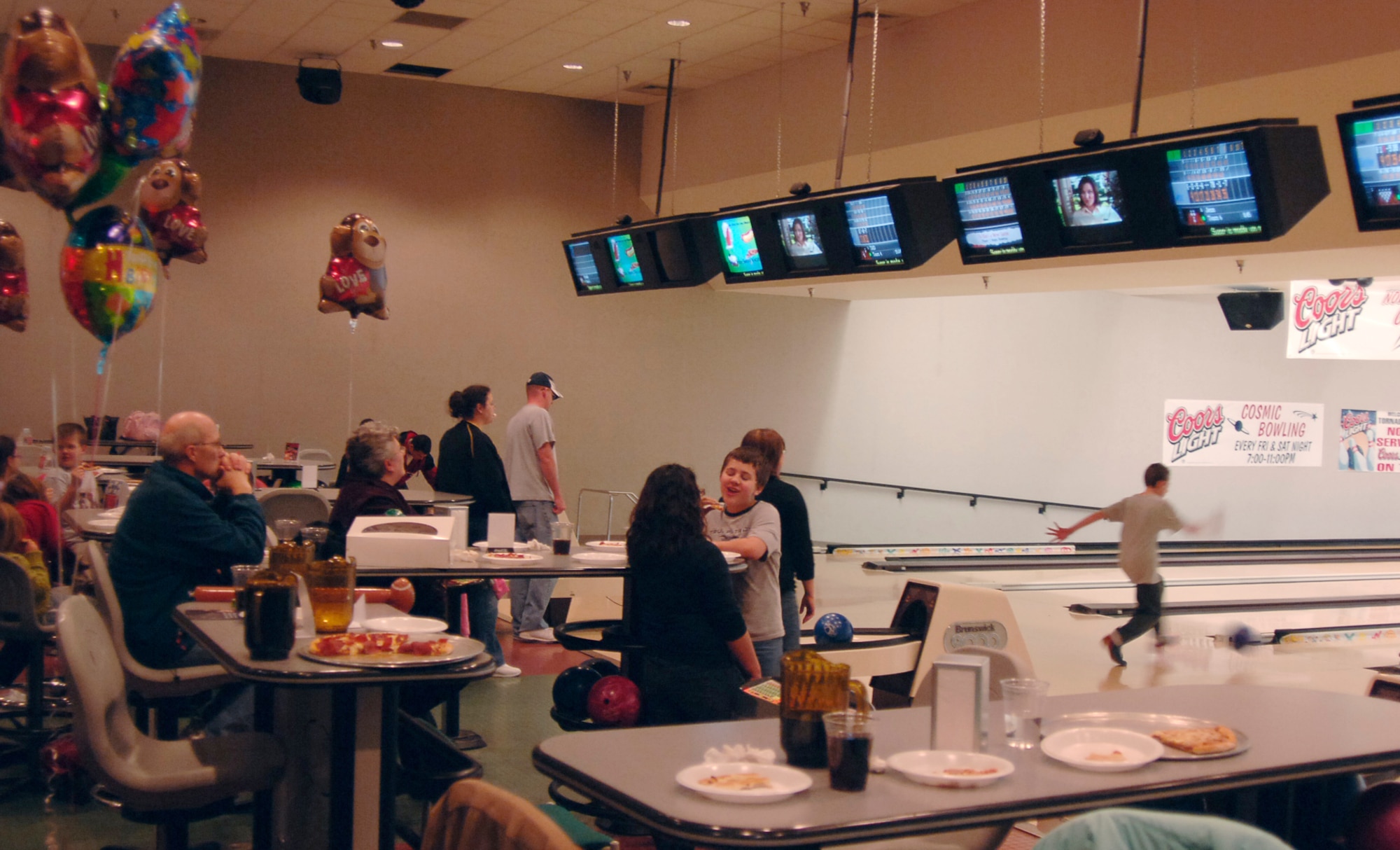 MCCONNELL AIR FORCE BASE, Kan. -- Team McConnell members enjoy pizza, bowling and drinks while answering trivia questions at Tornado Alley during Trivia Night, Jan. 30. If a trivia question was answered correctly the winner picked a prize.  (Photo by Airman 1st Class Maria Ruiz)