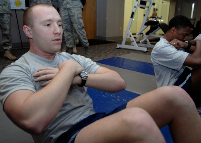 Jacob Wright performs a sit-up during the 437th Security Forces Squadron's completion of 100,000 push-ups and sit-ups during a 100-day Commander's Fitness Challenge at the base Fitness and Sports Center on base Jan. 30. The challenge is a base-wide event for teams of 10 to complete 100,000 push-ups and sit-ups in 100 days. Wright is a 437 SFS Raven apprentice. (U.S. Air Force photo/Senior Airman Katie Gieratz)