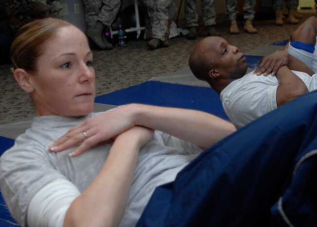 Meghan Donahue performs a sit-up during the 437th Security Forces Squadron's completion of 100,000 push-ups and sit-ups during a 100-day Commander's Fitness Challenge at the base Fitness and Sports Center on base Jan. 30. The challenge is a base-wide event for teams of 10 to complete 100,000 push-ups and sit-ups in 100 days. Donahue is a 437 SFS Raven apprentice. (U.S. Air Force photo/Senior Airman Katie Gieratz)