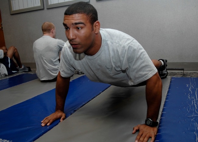 Anthony Harmon performs a push-up during the 437th Security Forces Squadron's completion of 100,000 push-ups and sit-ups during a 100-day Commander's Fitness Challenge at the base Fitness and Sports Center on base Jan. 30. The challenge is a base-wide event for teams of 10 to complete 100,000 push-ups and sit-ups in 100 days. Harmon is a 437 SFS Raven apprentice. (U.S. Air Force photo/Senior Airman Katie Gieratz)