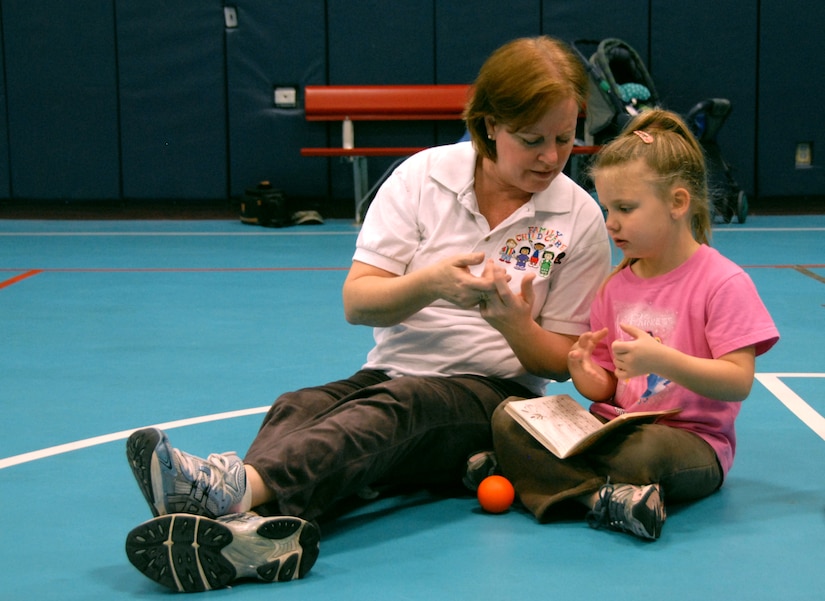 Sandy Borgerding sings a nursery rhyme with Kennedy Conaway in the Youth Programs Center gym Feb. 3. Mrs. Borgerding recently became a nationally accredited family child care provider through the National Association for Family Child Care. Mrs. Conaway is a family child care provider and Kennedy is the daughter of Tech. Sgt. Rachel Conaway of the 437th Aircraft Maintenance Squadron and Master Sgt. Christopher Conaway of the Summerville recruiting office. (U.S. Air Force photo/Airman Ian Hoachlander)