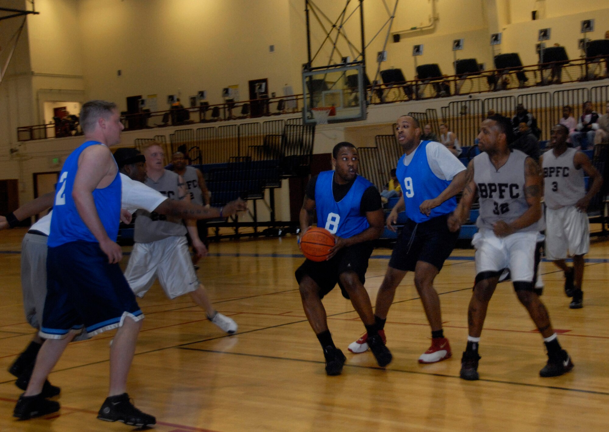 ELMENDORF AIR FORCE BASE, Alaska--Airman 1st Class Louis Hall looks for a chance to score during a Joint Base Elmendorf/Richardson basketball tournament at the base fitness center Jan. 28. Airman Hall is with the 90th Aircraft Maintenance Unit. (U.S. Air Force photo/Airman 1st Class Cynthia Spalding)
