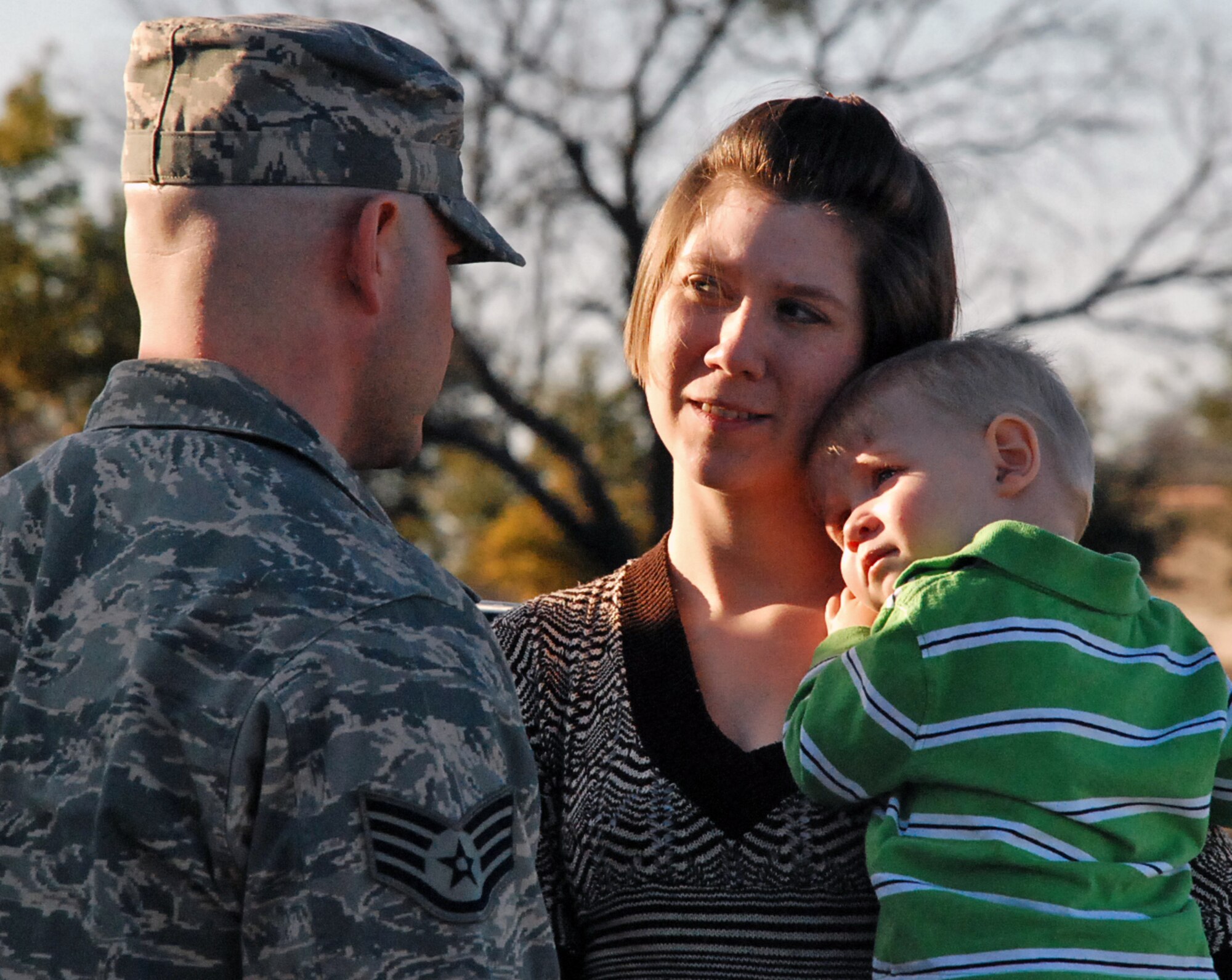 LAUGHLIN AIR FORCE BASE, Texas – Staff Sgt. John Major, 47th Force Support Squadron, is welcomed home by his wife Jennifer and one-year-old son Michael after a four month deployment with several other Airmen here Jan. 28. (U.S. Air Force photo by Airman 1st Class Sara Csurilla)