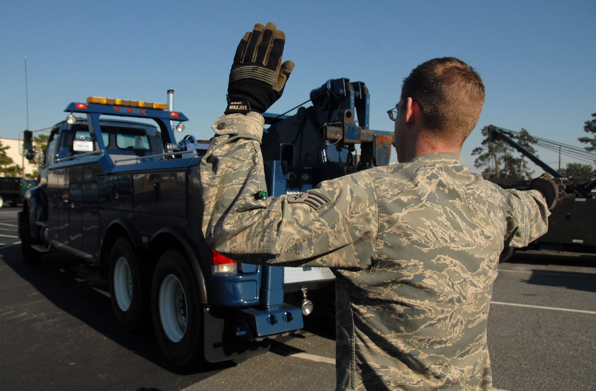 Senior Airman Shane O?Kelley spots a driver moving a 20-ton wrecker during training in the vehicle operations yard on Charleston AFB Feb. 4. Airmen working in the vehicle operations yard are also responsible for disabled vehicle recovery, picking up aircrew members and for picking up parts involving anything from screws to aircraft engines and delivering them to different organizations on base. Airman O?Kelley is a documented cargo supervisor with the 437th Logistics Readiness Squadron. (U.S. Air Force photo/Airman 1st Class Melissa White)