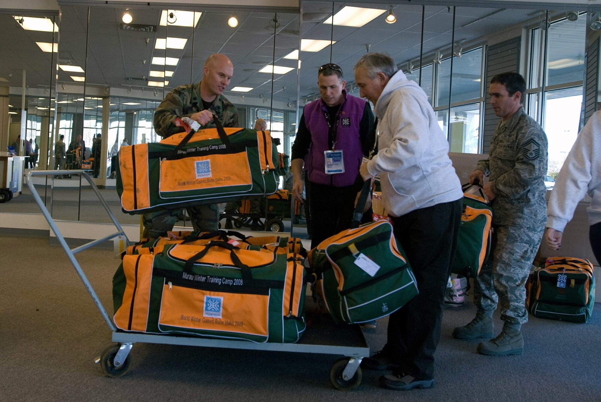 Idaho Air National Guardsmen Lt. Col. Neal Murphy (left) and Senior Master Sgt. Gary Weiskircher move baggage and equipment for members of Team Ireland Feb. 3 at the 2009 Special Olympics World Winter Games Delegate Welcome Center in Boise, Idaho.  Airmen and Soldiers from the Idaho National Guard are providing logistical and emergency-service support to the winter games which run Feb. 7 to 13 at venues throughout Idaho.  Colonel Murphy is the executive officer for the 124th Wing at Gowen Field in Boise, and Sergeant Weiskircher is with the 124th Logistics Readiness Squadron.   (U.S. Air Force photo/Senior Airman Robert Barney)