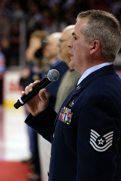 Technical Sgt. Adrian Bouldin, 92nd Force Support Squadron unit deployment manager Fairchild Air Force Base, sings the National Anthem before the Spokane Chiefs hockey game at the Spokane Arena, Jan. 31.(U.S. Air Force photo / Staff Sgt. Anthony Ennamorato)