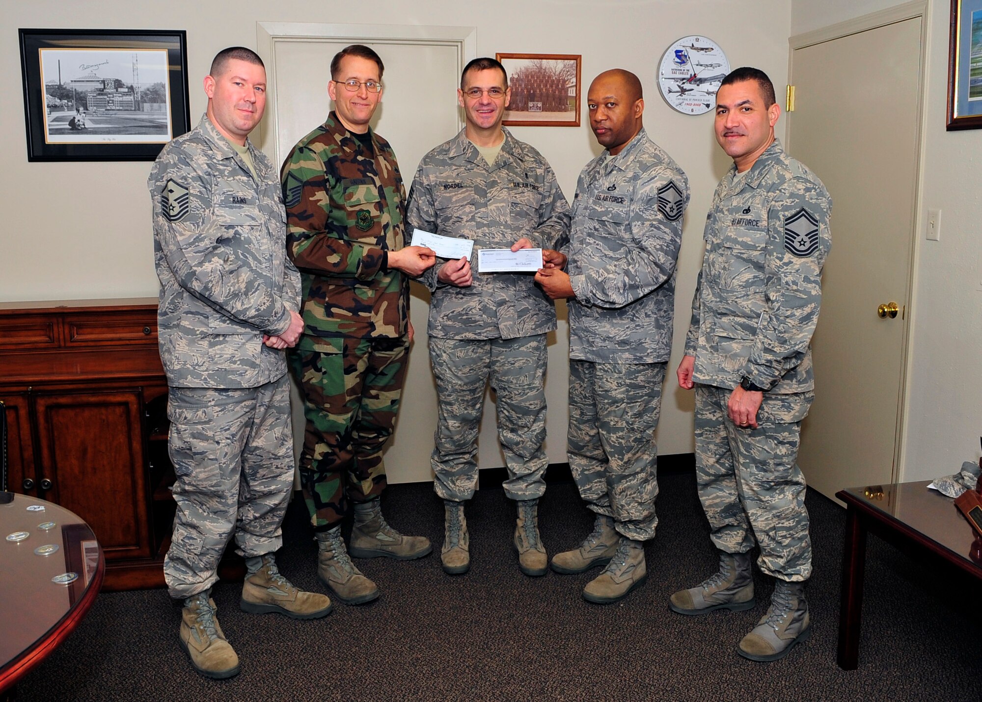 Senior Master Sgt. Wesley Mathias, 92nd Operations group Superintendent and outgoing Air Force Sergeants Association president, Chapter 1462; Master Sgt. Lester Gaither, 92nd Maintenance Squadron Production Supervisor and incoming AFSA president, Chapter 1462; Master Sgt. Kenneth Rains, 92nd Medical Group first sergeant and AFSA treasurer; Senior Master Sgt. Gary Gonzalez, 373rd Training Group Detachment 13 and incoming AFSA vice president, chapter 1462, present Chief Master Sgt. David Nordel, 92nd Air Refueling Wing Command Chief with two $51 checks - one from  the 1462 Chapter and one from the AFSA Division 14 President, Chief Mater Sgt. Ret. Yeomans Feb. 3. 

From Nov. 5 to Dec. 31, 2008, AFSA Chapter 1462 had a recruiting drive with an outcome of 51 new members. With a pledge from the Division 14 President CMSgt. Ret. Yeomans to contribute $1 per recruit toward the Wing Command Chief fund. The Chapter pledged to match those funds from Division 14, dollar-to-dollar. The checks from both the Division 14 and Chapter 1462 will be used for any program on Fairchild at the Command Chief’s discretion.
(U.S. Air Force photo / Airman 1st Class Melissa L. Barnett) 
