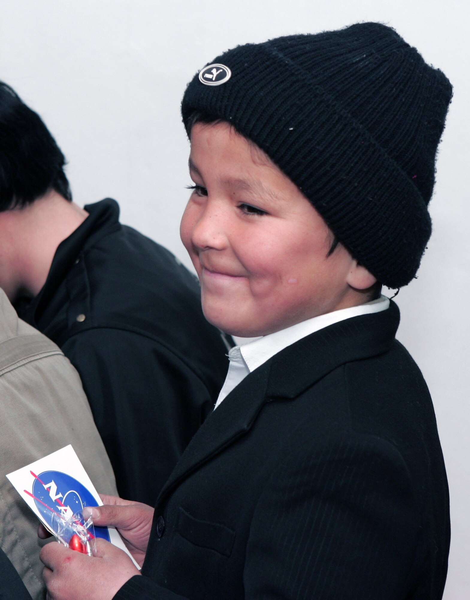 A young boy from the Jany-Pakhta village school smiles after receiving souvenirs from the Space Shuttle Endeavour STS-126 astronauts who visited his school Jan. 29 near Manas Air Base, Kyrgyzstan. The six space shuttle crewmembers spoke of the journey, which launched from Kennedy Space Center in Florida Nov. 14 and returned Nov. 30, 2008. (U.S. Air Force photo/Tech. Sgt. David Jones) 
