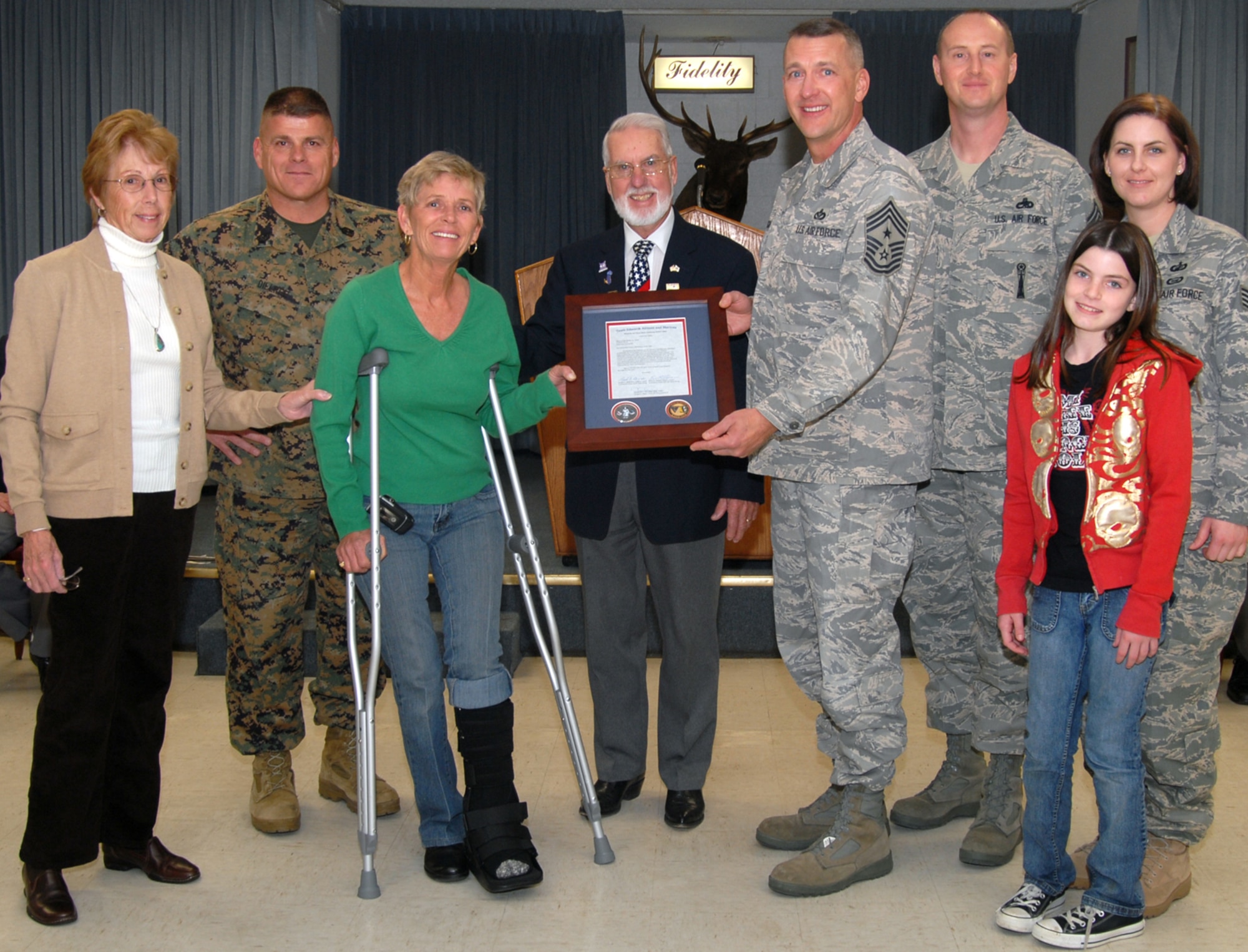 Team Edwards, represented by Chief Master Sgt. Mark Brejcha (fourth from left), 412th Test Wing command chief, presents a plaque of appreciation to the Elk's Lodge in Palmdale, Calif., Jan. 7. The Elk's Lodge put on a cost-free holiday party for military children. This is part of Team Edwards' thanksgiving to local community that provided joy to military families during the holiday season.(Air Force photo by Senior Airman Julius Delos Reyes)