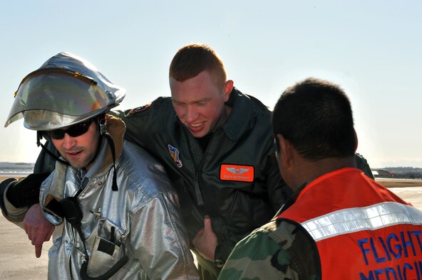 OFFUTT AIR FORCE BASE, Neb. -- Jason Bloom, a firefighter with 55th Civil Engineer Squadron, carries 1st Lt Kevin Meverhoff, a member of the 338th Combat Training Squadron, to flight emergency medical technicians Feb. 2. Offutt personnel were participating in a Major Accident Response Exercise to help enhance their skills and response time if a real accident were to occur. Photo By: Charles Haymond 