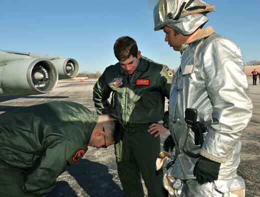 OFFUTT AIR FORCE BASE, Neb.-- James Rush, a firefighter with the 55th Civil Engineer Squadron, tries to identify why 2nd Lt's Ian Cadorna and Shain Bestick, members of the 338th Combat Training Squadron, departed an aircraft  with nausea symptoms during a Major Accident Response Exericse Feb. 2. Offutt personnel were participating in the M.A.R.E. to help enhance their skills and response time if a real accident were to occur. Photo By: Charles Haymond 

