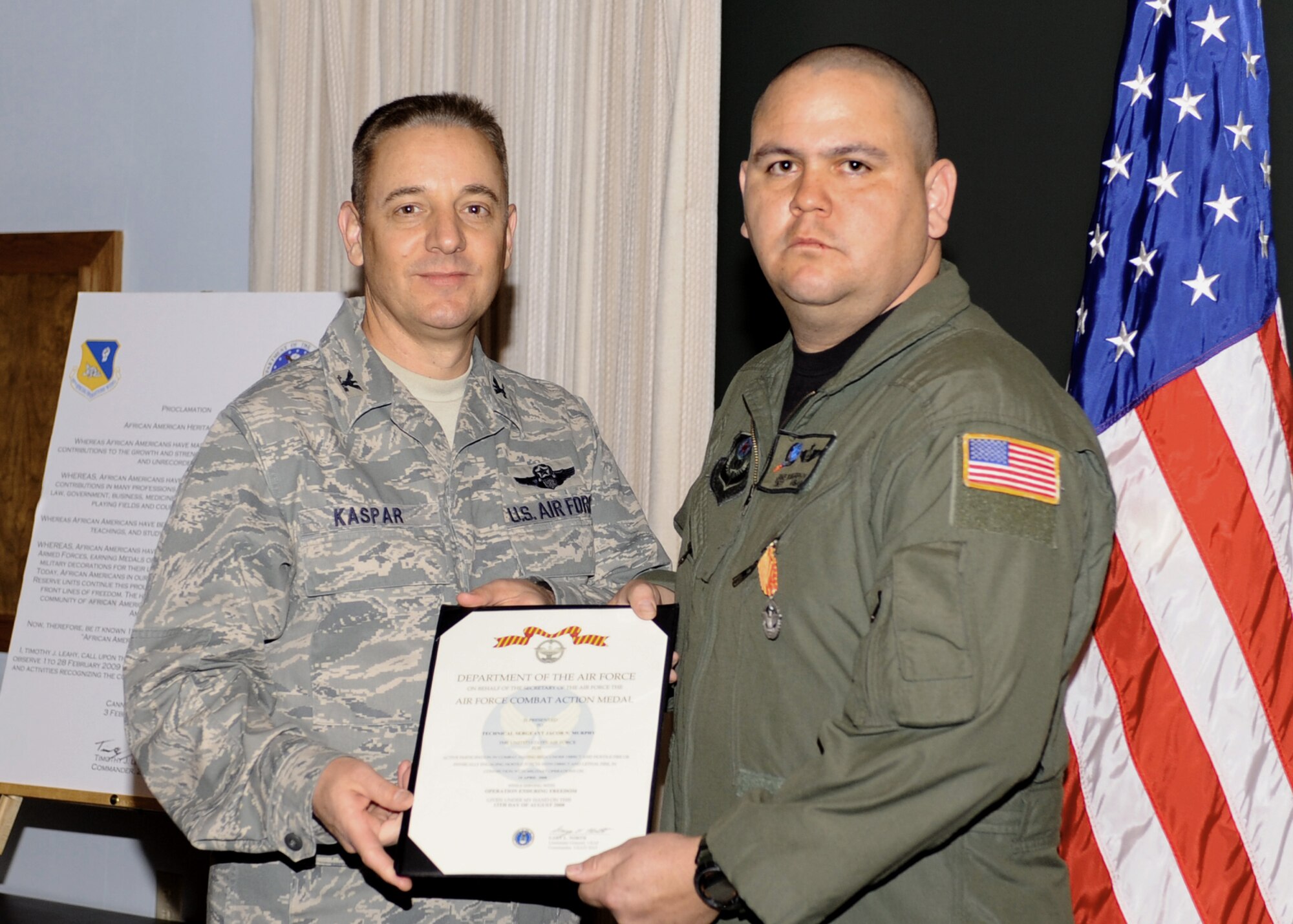 CANNON AIR FORCE BASE, N.M. -- Tech. Sgt. Jacob Murphy, 16th Special Operations Squadron, Det. 1, receives the Air Force Combat Action Medal presented to him by Col. Hans Kaspar, 27th Special Operations vice wing commander. Sergeant Murphy received the award at the weekly wing staff meeting on Feb. 3. (U.S. Air Force photo/Airman 1st Class Evelyn Chavez) 