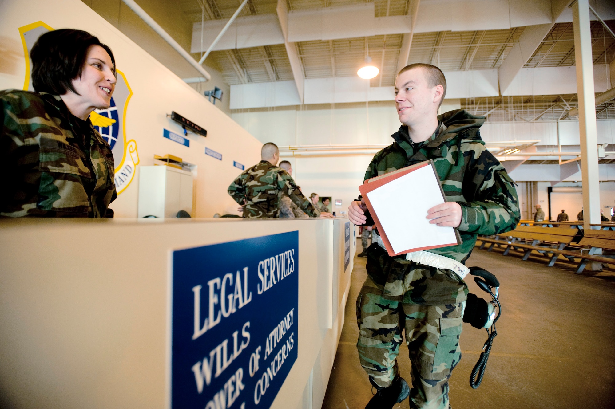 Capt. Constance Wilkes offers legal services to Airman 1st Class David Morris in preperation for his deployment to McChord Air Force Base, Wash., Feb. 1 at Elmendorf AFB, Alaska. Five C-17 Globemaster IIIs and around 130 operations and maintenance personnel are heading to McChord AFB as a precautionary measure due to increased volcanic activity associated with nearby Mount Redoubt. Captain Wilkes is assigned to the 3rd Wing Legal Office, and Airman Morris is assigned to the 703rd Aircraft Maintenance Squadron. (U.S. Air Force photo/Senior Airman Jonathan Steffen) 

