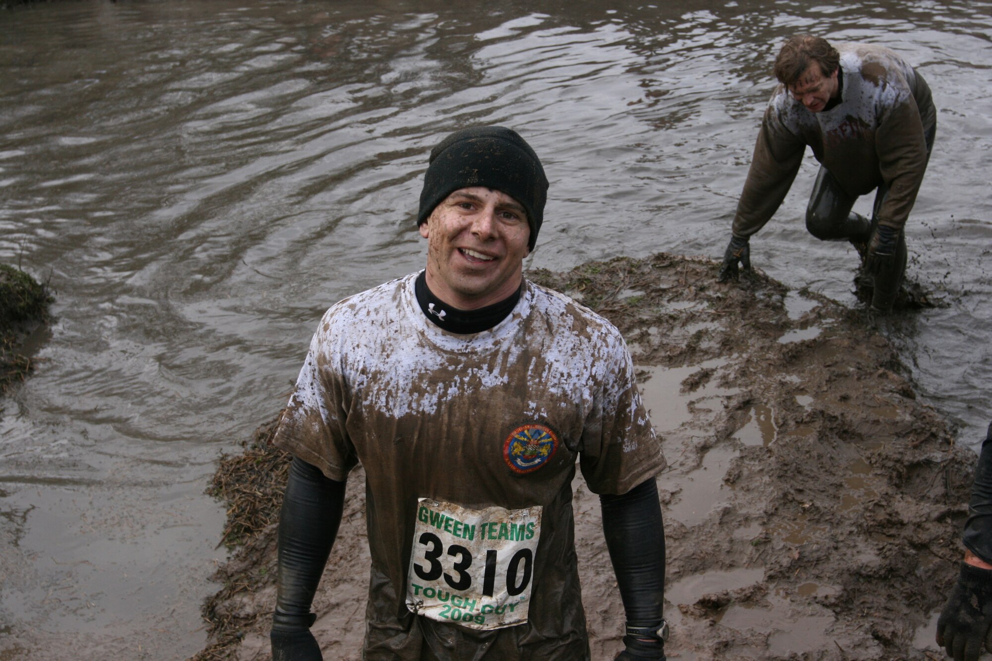 Marine Corps Sgt. Matt Johnson smiles as he tackles a water obstacle during the February 1, 2009 Tough Guy Winter "Bold and the Beautiful" challenge in Perton, England.  Sgt. Johnson was part of the JAC HAMMERS team from RAF Molesworth all of whom completed the course and can officially call themselves "Tough Guys." (U.S. Air Force Photo by Chief Petty Officer Kieth Van Hoosen)