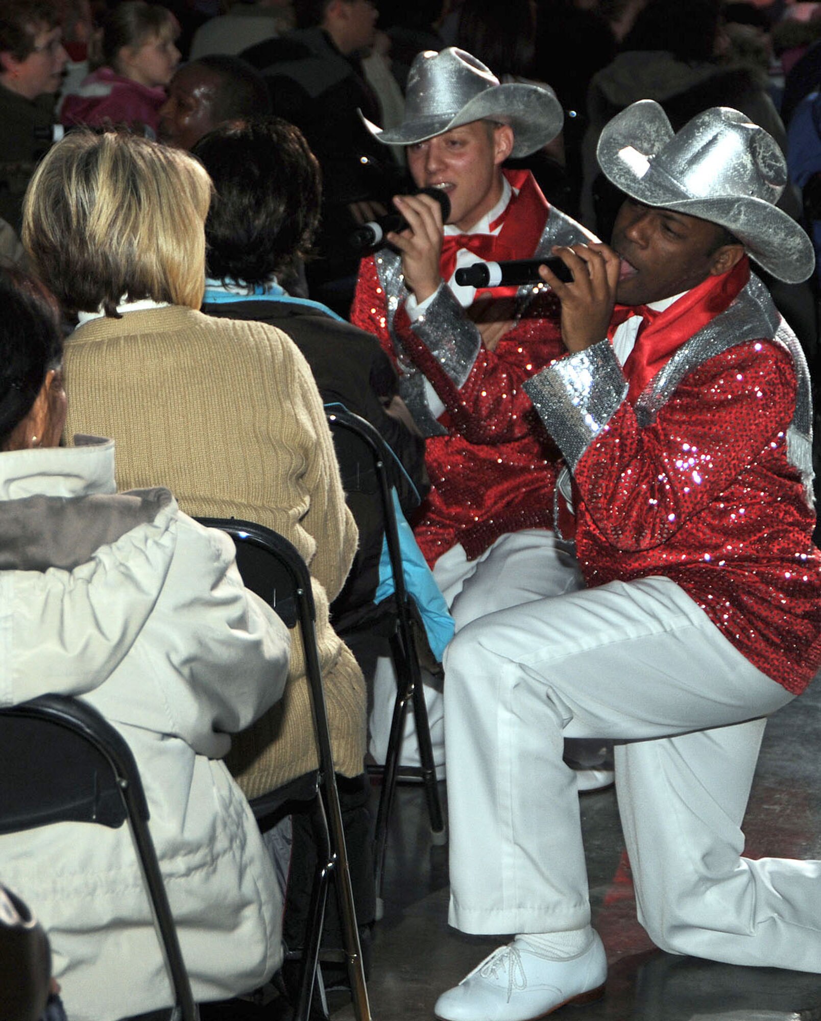 SCOTT AIR FORCE BASE, Ill. -- Airman 1st Class David Butler (left) and Senior Airman Tommie Crutcher, both members of Tops in Blue, sing some country favorites to members of the audience during their Scott performance Thursday night. (U.S. Air Force photo/Airman 1st Class Wesley Farnsworth)