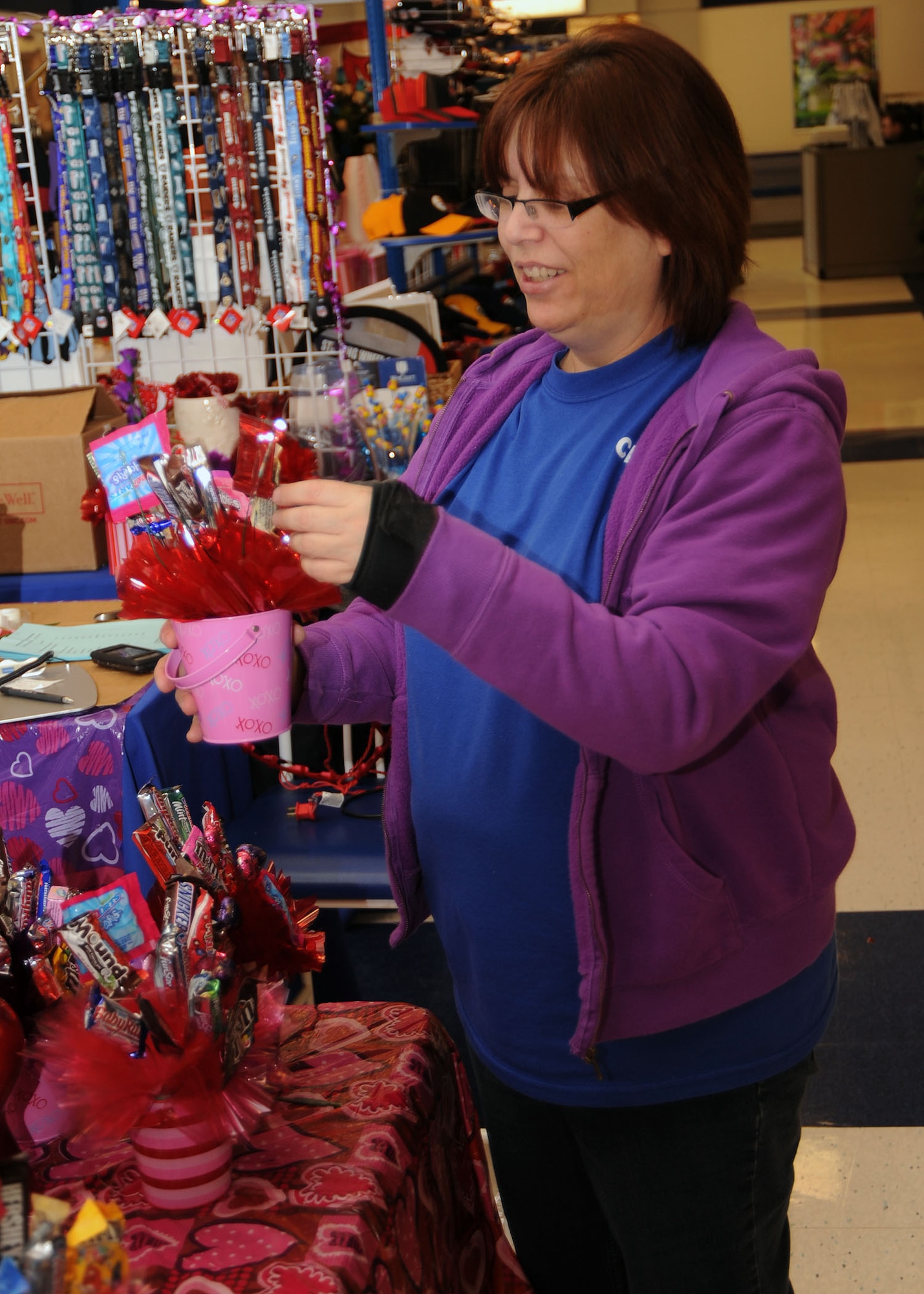 SCOTT AIR FORCE BASE, Ill. -- Jackie Greene straightens a bouquet of mini candies inside the Base Exchange Tuesday. Ms. Greene is with Jackie’s Jewels,  a display just inside the BX doors that offers bouquets of wooden flowers and sweet candies.(U.S. Air Force photo/Airman 1st Class Wesley Farnsworth)