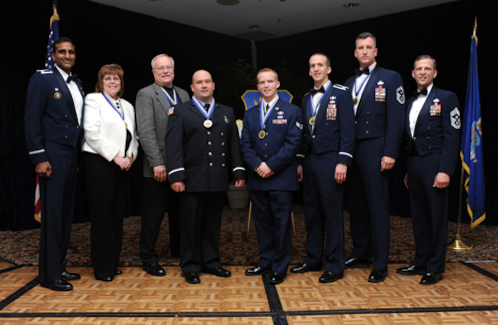 Left, Col. Balan Ayyar, 305th Air Mobility Wing commander, and Chief Master Sgt. John Gillette, 305th AMW command chief (far right,) pose with the 305th AMW 2008 Annual Award winners during a ceremony Jan. 30 at The Club. The winners (from left to right): Denise McLane, 305th Air Mobility Wing Civilian Category III; Lawrence Wilshere, 305th Maintenance Squadron Civilian Category II; Anthony Ellison, 305th Civil Engineer Squadron Civilian Category I; Senior Airman Brian Buhrer, 305th CES Airman of the Year; Capt. Matthew Stanford, 305th CES senior CGO of the Year; and Senior Master Sgt. Philip Gaudette, 305th Aerial Port Squadron First Sergeant of the Year. 
