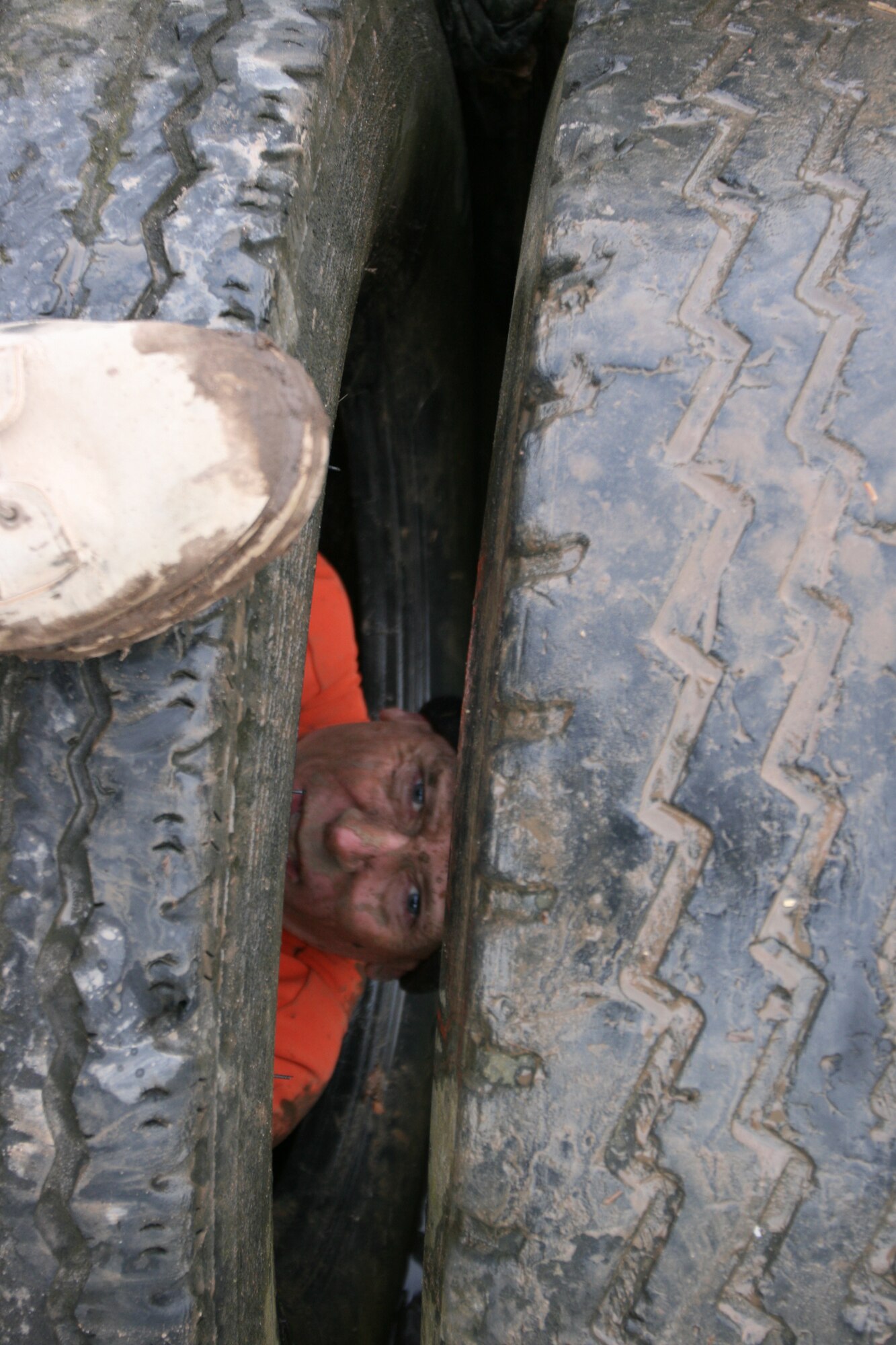 JAC Commander, Marine Corps Col. Pete Devlin grimaces as he navigates a tire obstacle during the February 1, 2009 Winter Tough Guy challenge in Perton, England.  Col. Devlin led an eight man team from RAF Molesworth all of whom completed the 8 mile course of obtacles, water, mud and more mud with a wind chill factor of -8 degrees Celsius.  (U.S. Air Force Photo by Chief Petty Officer Keith Van Hoosen)