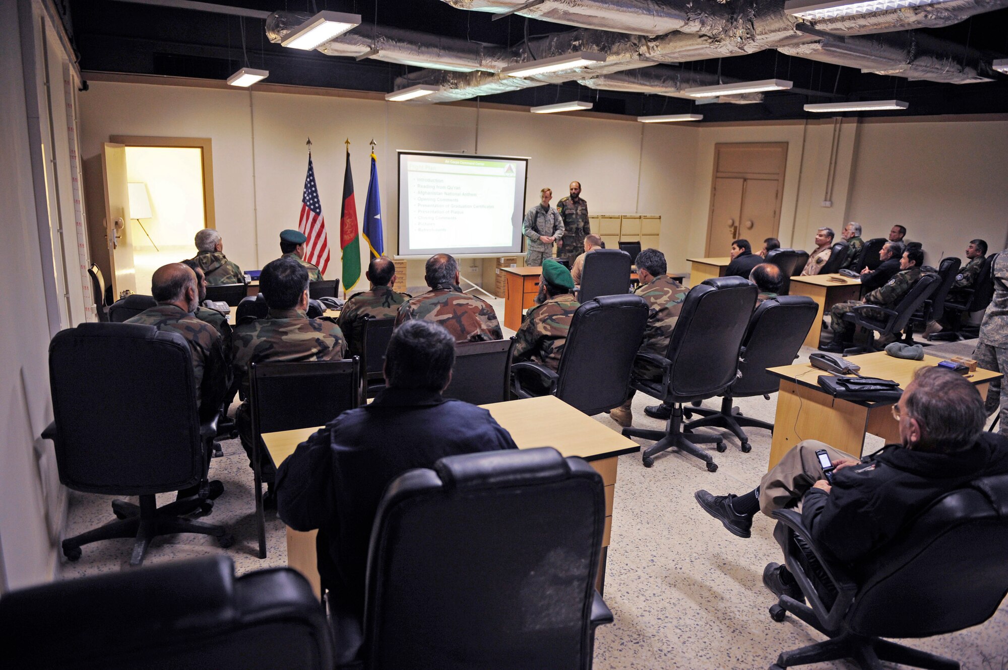 Afghan army air corps members sit through a graduation ceremony for the Afghan Command and Control Center Course Jan. 24 at Kabul, Afghanistan. The command and control course taught by American Airmen is four weeks long and graduated 16 members. (U.S. Air Force photo/Staff Sgt. James L. Harper Jr.) 

