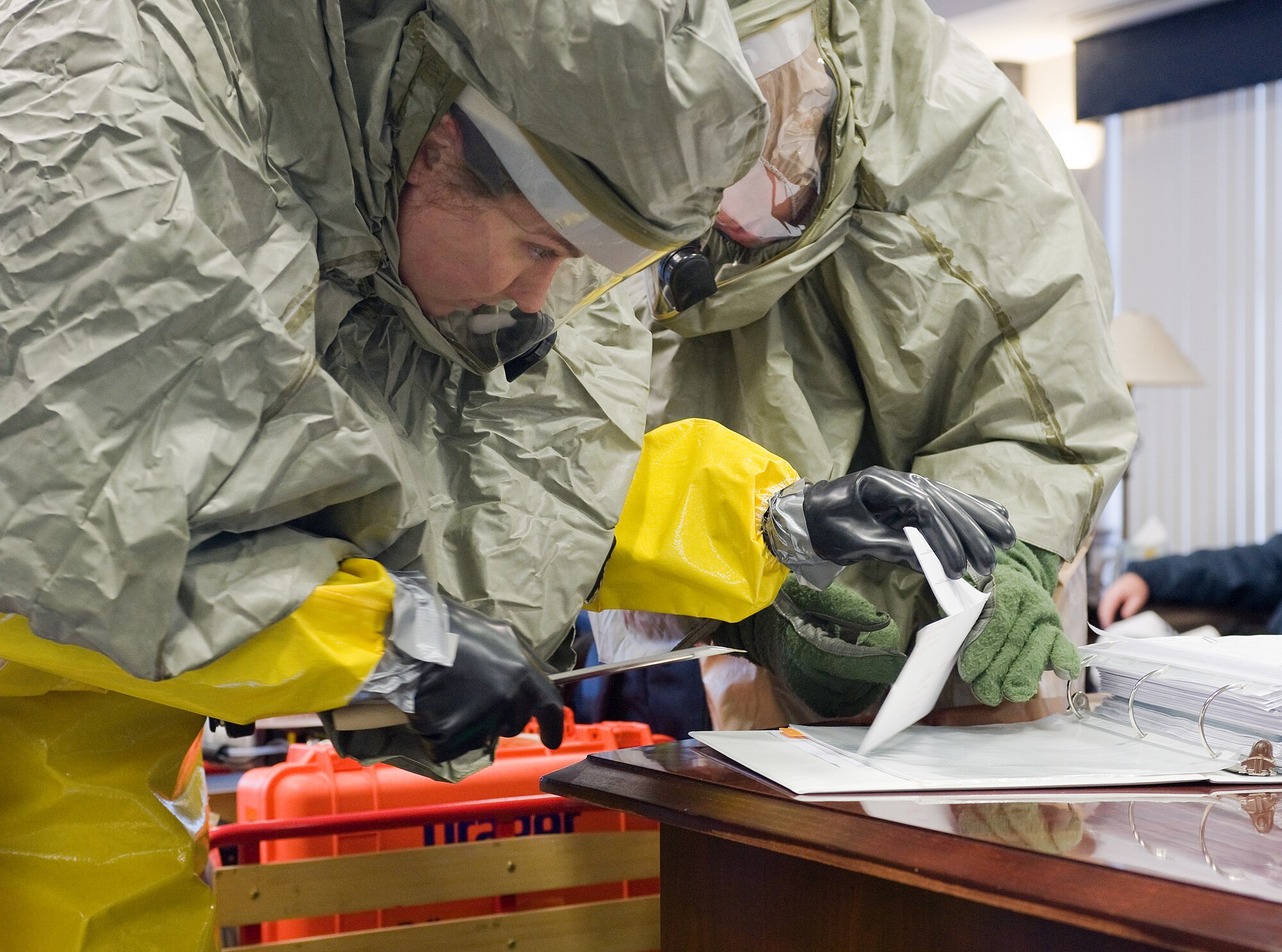 (Left) Airman 1st Class Kendra Ketonen, 436th Civil Engineer Squadron Emergency Management, and Senior Airman Crystal Dark, 436th Aerospace Medicine Squadron Bio-Environmental Engineer, prepare to sample a ?suspicious? powder during an a Major Accident Response Exercise on Dover Air Force Base Jan. 27.  (U.S. Air Force photo/Tom Randle)
