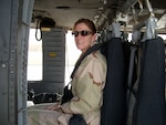 Rhonda Chavez, 12th Contracting Squadron team lead, prepares for a helicopter ride during her deployment to Kuwait. Ms. Chaves and Senior Airman Ellizabeth Plack were recently named AETC Outstanding Contingency Contracting and Outstanding Contracting Enlisted Member award winners, respectively. (Courtesy photo)