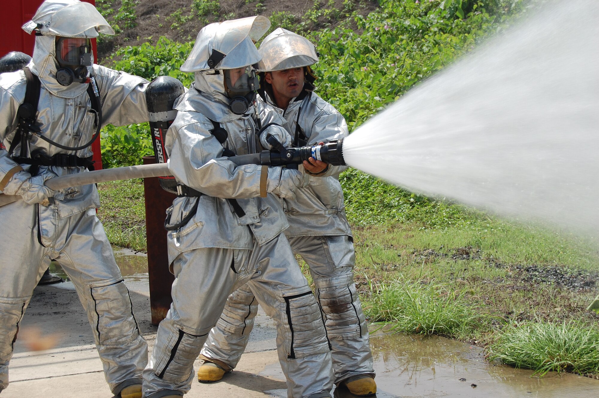 Mr. Herman Oleas (far right), FOL Manta Fire and Emergency Services station captain, instructs firefighters from Colon, Ecuador before a simulated structural fire here Jan. 31.  FOL Manta personnel provided hands-on medical and fire response training to a group of 40 firefighters and firekids from Colon, Ecuador. (U.S. Air Force photo by 1st Lt. Beth Woodward)