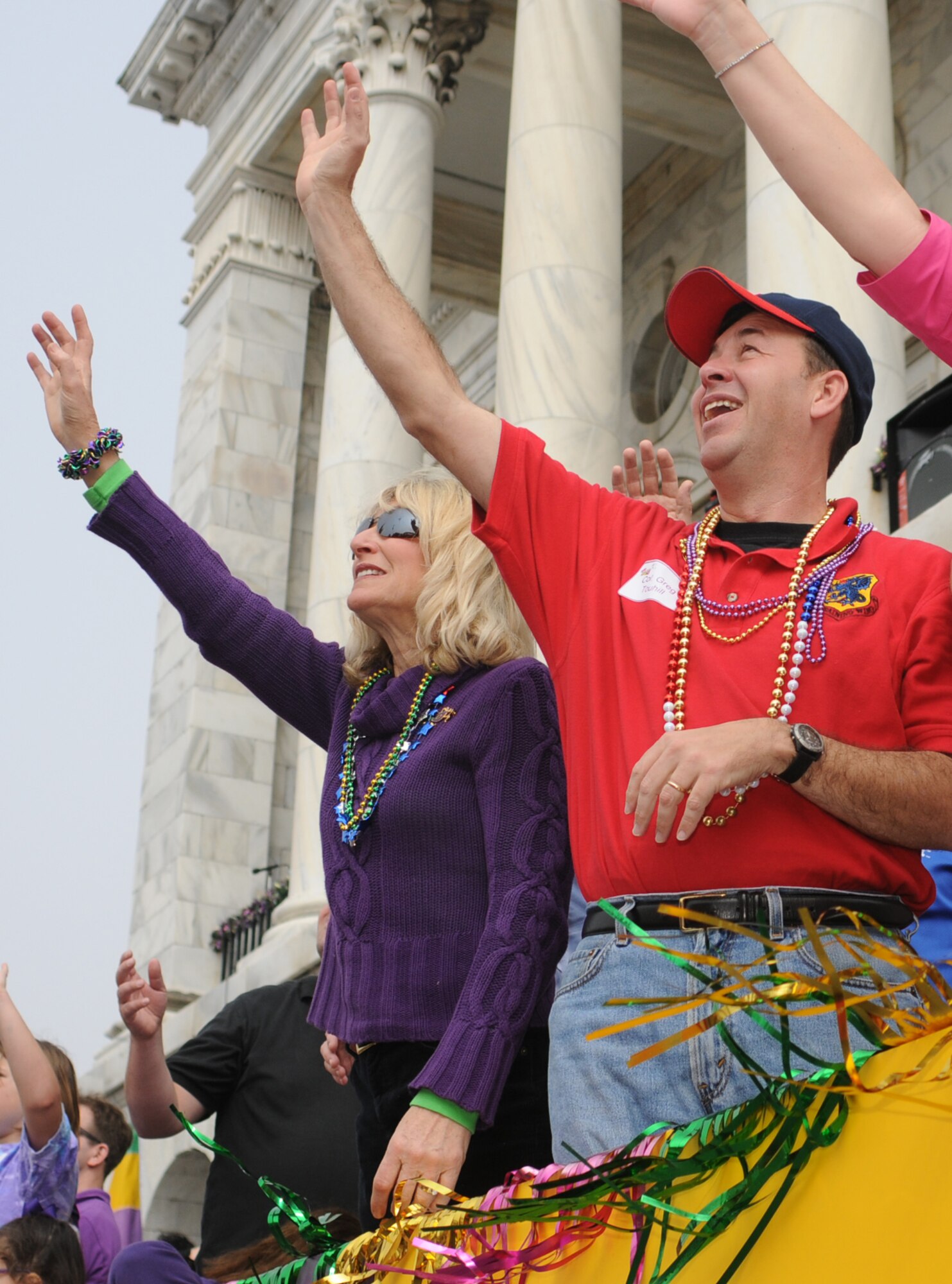 Paula Gould, wife of Maj. Gen. Mike Gould, former 2nd Air Force commander, and Brig. Gen. Greg Touhill, 81st Training Wing commander, try to catch beads and other trinkets at last year’s Gulf Coast Carnival Association parade in Biloxi.  (U.S. Air Force photo by Kemberly Groue)