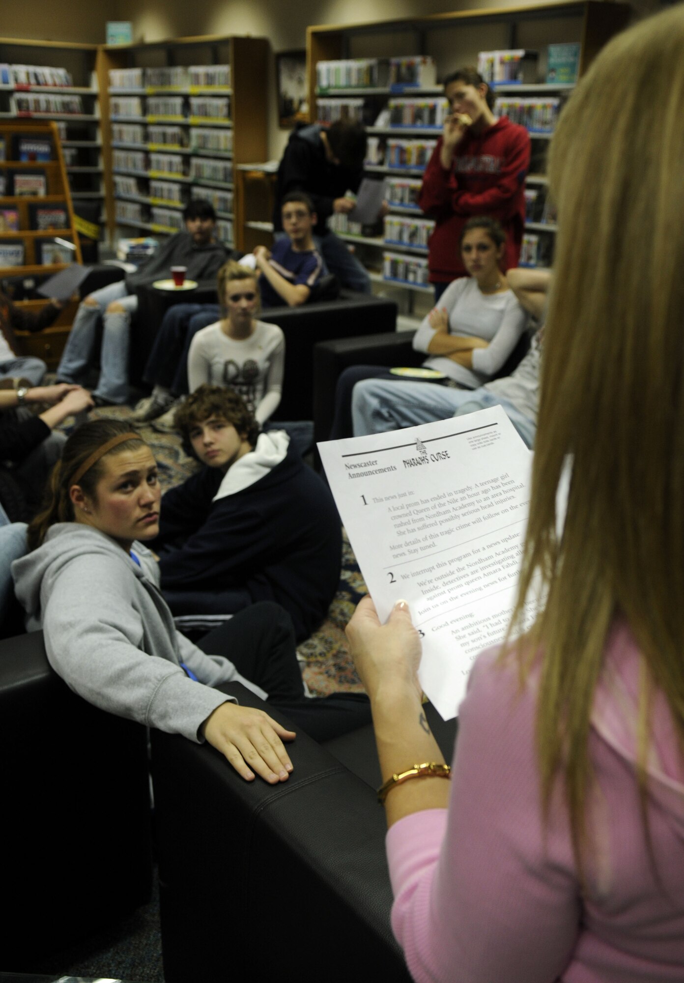 Patty Gill, Incirlik’s library programs director, reads “The Pharaoh’s Curse”, a murder mystery script, during the library’s Mystery Night Feb 2.  The ‘Mystery Night’ was open to all Incirlik Unit School students; with prizes for the team that solved the mystery correctly. (U.S. Air Force photo/Airman 1st Class Amber Russell)