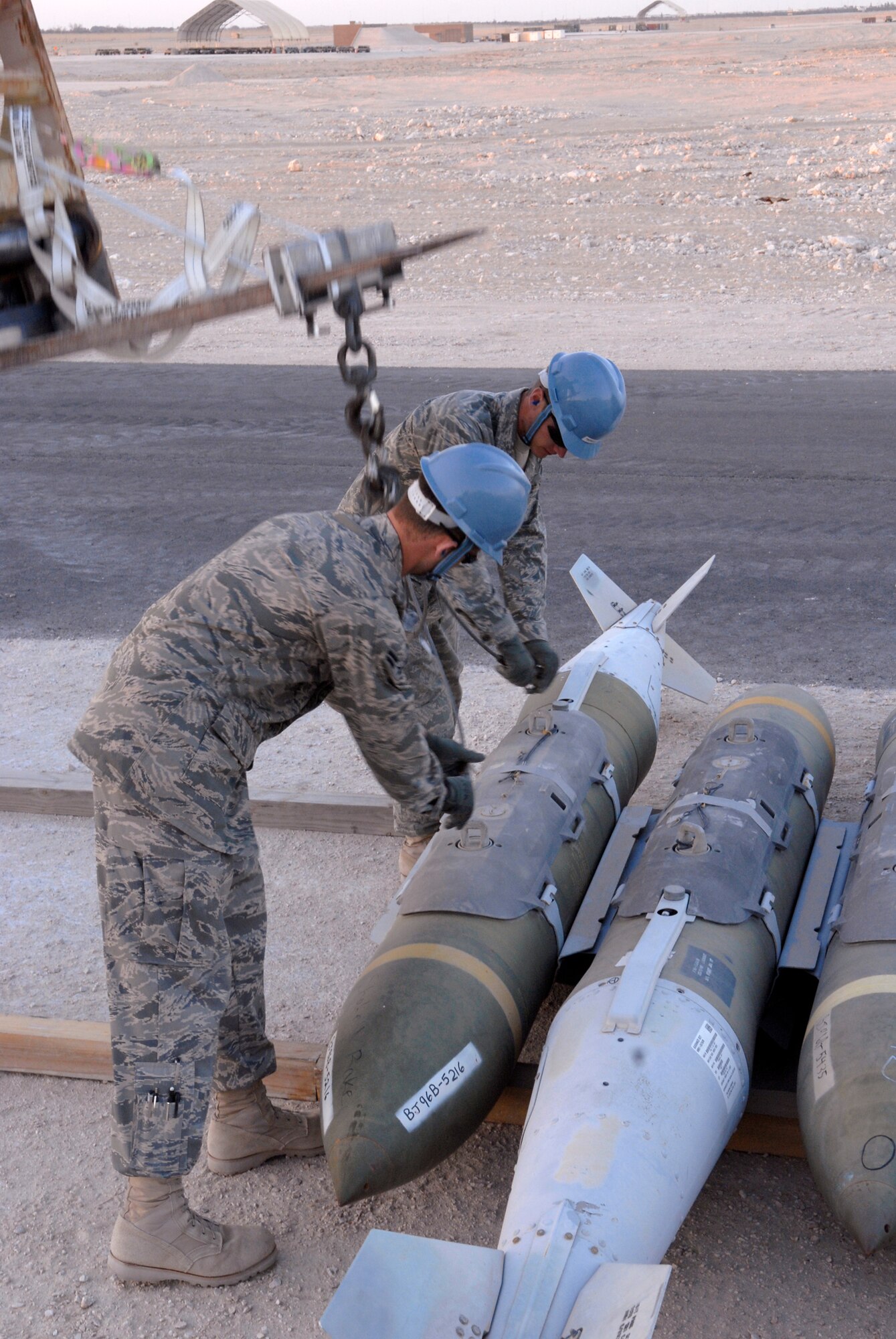 Airman 1st Class Brian Foster, a 379th Expeditionary Maintenance Squadron (EMXS) Ammunitions Systems Journeyman, and Airman Bryan Newcomer, a 379th EMXS Ammunitions Systems Apprentice, move GBU-31bombs during the annual munitions serviceability inspection here Feb. 3, 2009, at an undisclosed location in Southwest Asia.  Airman 1st Class Foster hails from Ellijay, Ga. and Airman Newcomer is from Suwanee, Ga.  Both are deployed from Dyess AFB., Texas in support of Operation Iraqi and Enduring Freedom and Combined Joint Task Force- Horn of Africa.  (U.S. Air Force Photo by Airman 1st Class Andrew Satran/Released)