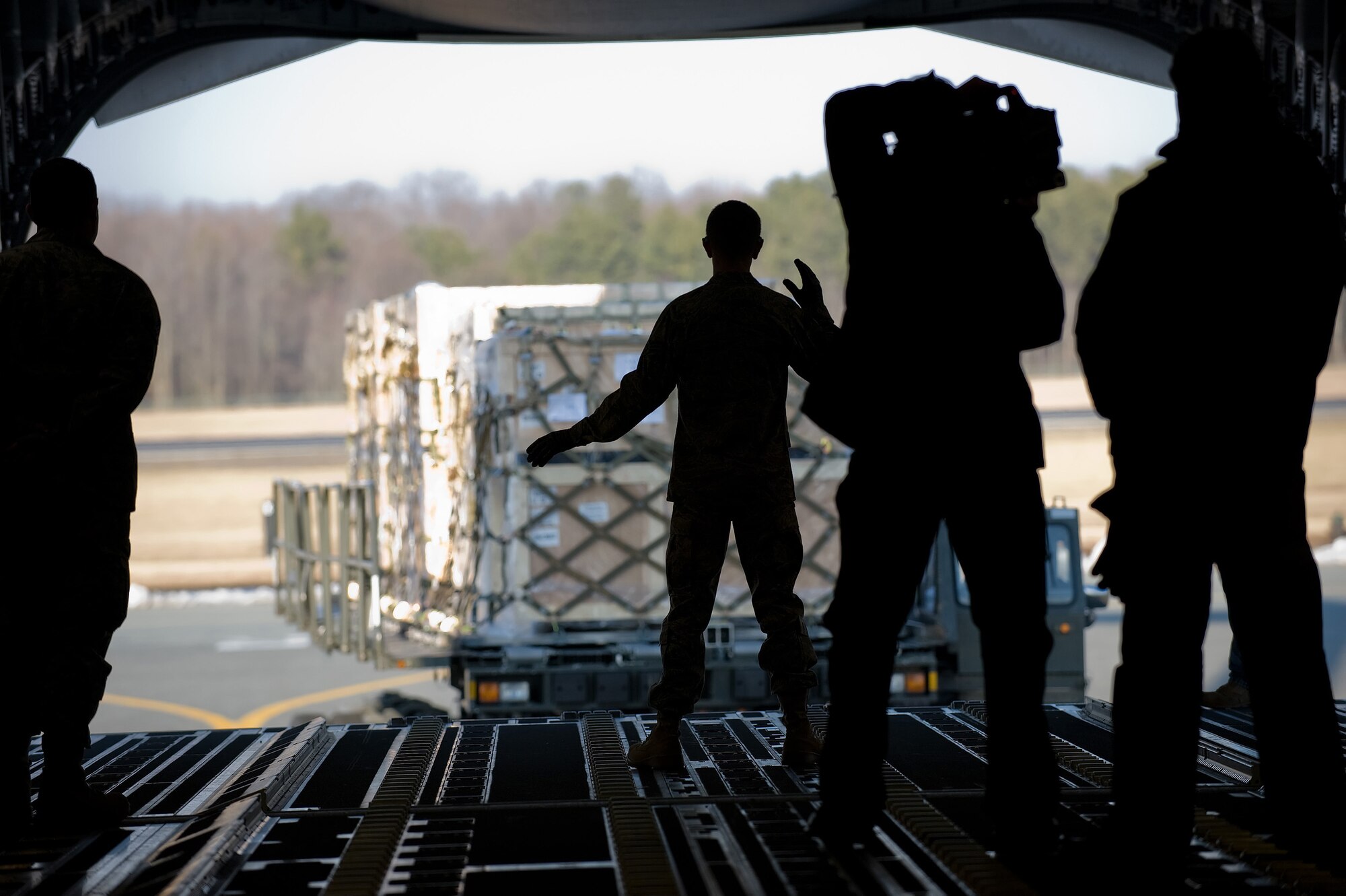 436th Aerial Port Squadron Airmen load pallets onto a C-5 Galaxy, while a filmcrew member captures the process on Dover Air Force Base Jan. 30. The crew was at Dover to film an Air Force Smart Operations for the 21st Century video, which is scheduled to be used Air Force wide to bolster AFSO-21 initiatives. (U.S. Air Force photo/Jason Minto)