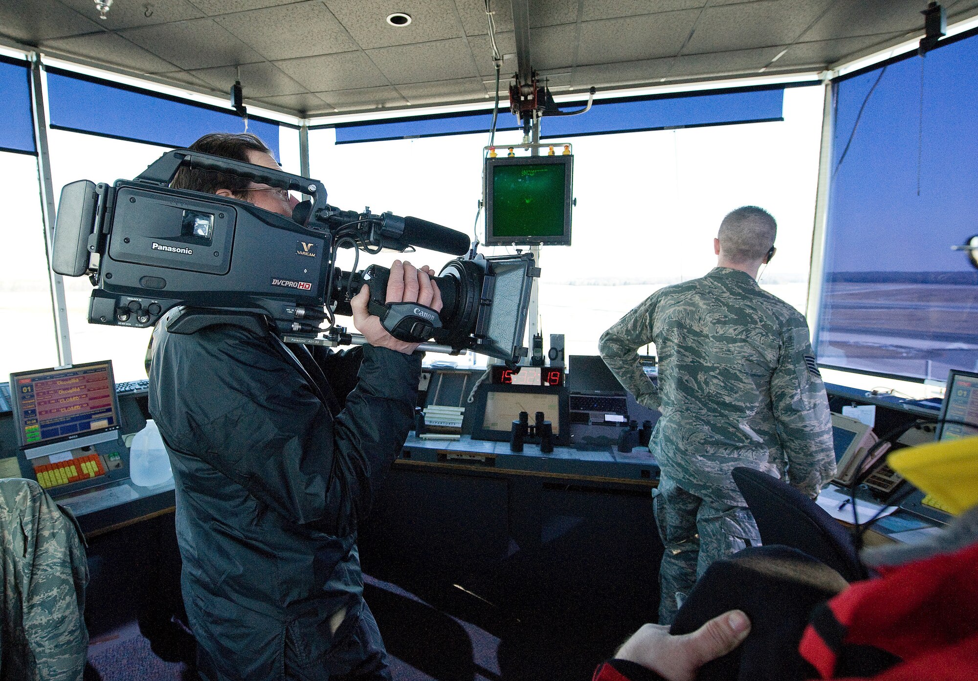 A contracted film crew cameraman captures Air Traffic Controllers in the line of duty during filming of an Air Force Smart Operations for the 21st Century video on Dover Air Force Base Jan. 30. Dover is noted as being the Air Mobility Command showcase base for AFSO-21. (U.S. Air Force photo/Tom Randle)