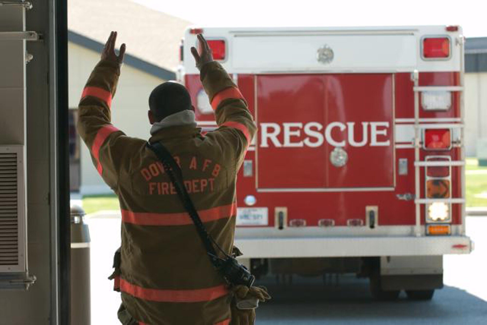Airman 1st Class Mark Arnold, 436th Civil Engineer Squadron Fire Department, directs a fire truck back into the fire station after responding to a call. (U.S. Air Force Photo / Jason Minto) 