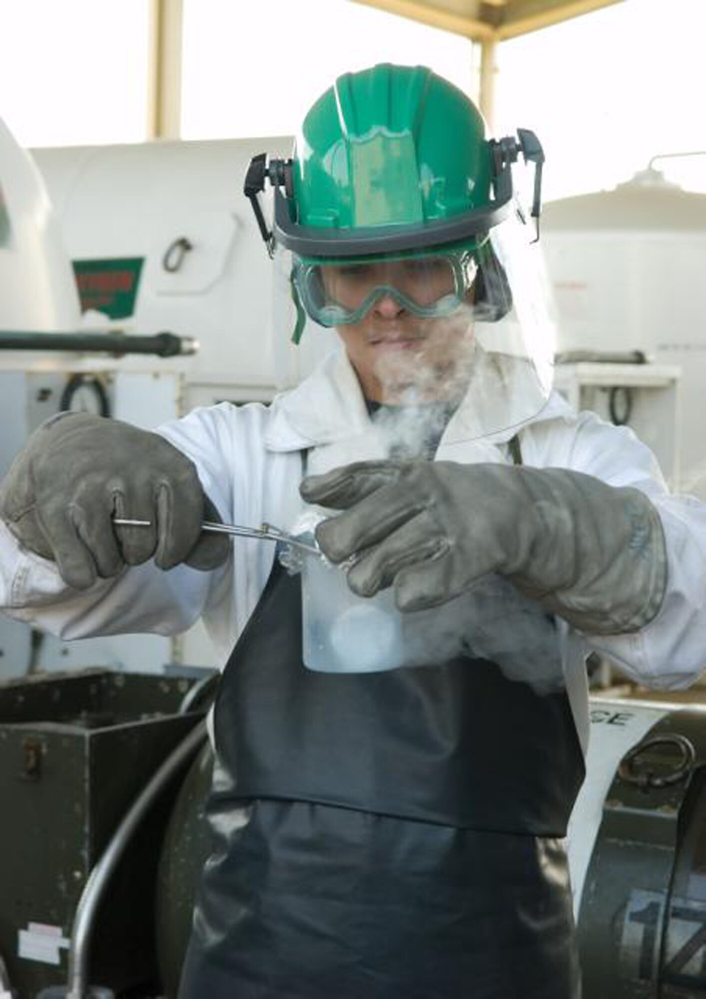 Senior Airman Joshua Westfall, 436th Logistics Readiness Squadron, takes samples of liquid oxygen before loading it onto a trailer. (U.S. Air Force Photo / Jason Minto) 