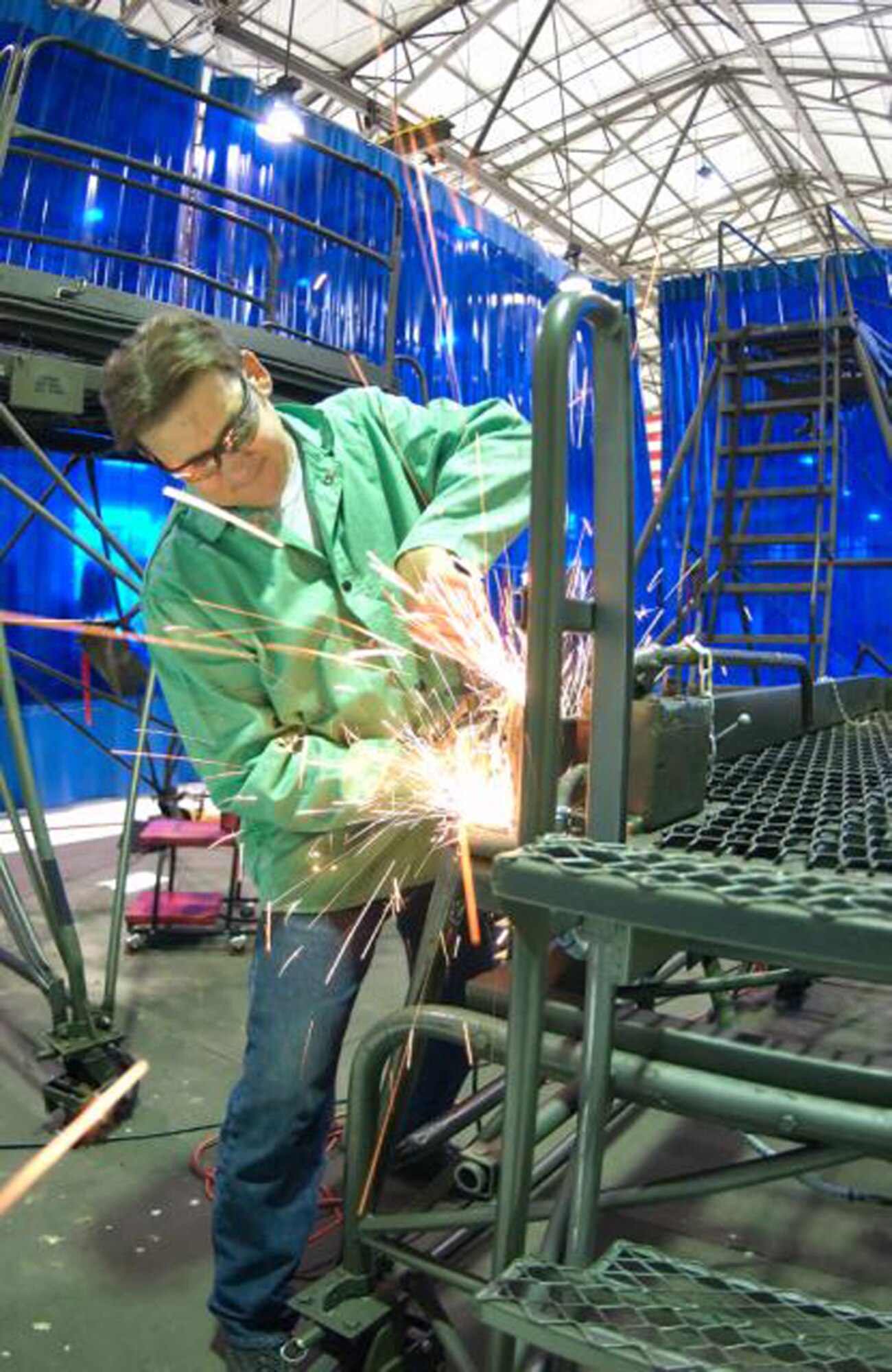Mike Stronko, 436th Maintenance Squadron, grinds a hand rail on a B-4 stand before a safety check. (U.S. Air Force Photo / Jason Minto) 