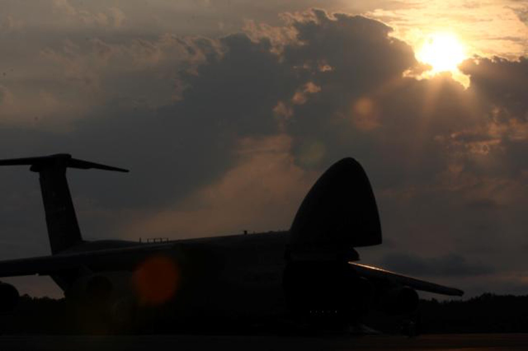 Sunrise on the flight line at Dover AFB. A C-5 Galaxy soaks in the early morning sun. (U.S. Air Force Photo / Roland Balik) 