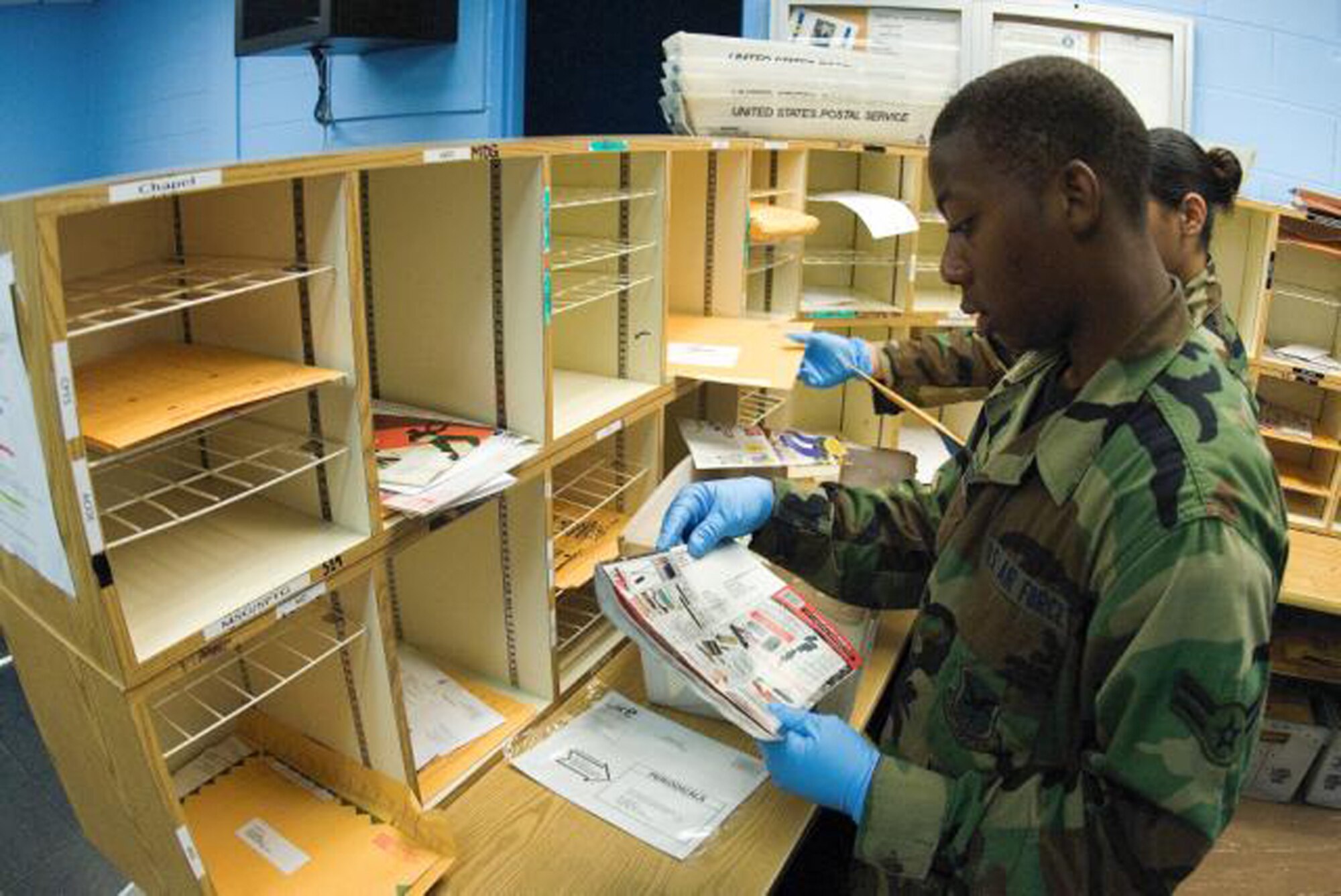 Airman 1st Class Randolph Littles, 436th Communications Squadron, sorts mail at the Base Post Office. (U.S. Air Force Photo / Roland Balik) 