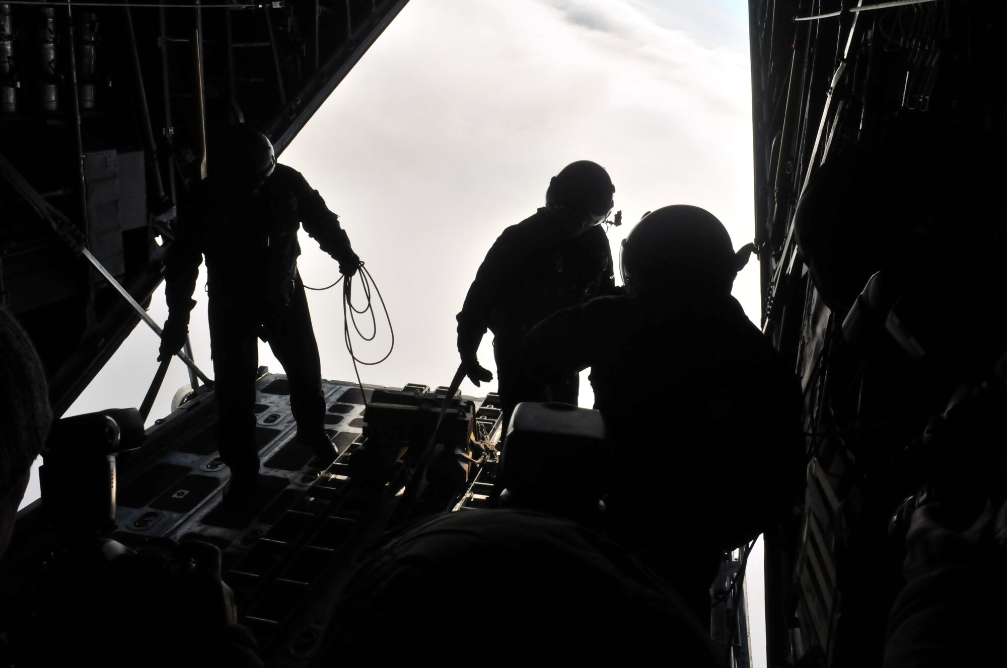 Loadmasters from the U.S. and Polish Air Forces demonstrate a low level air drop from a C-130 Hercules, Jan. 28, 2009, near Powdiz Air Base, Poland. The demonstration gave U.S.-trained Polish crewmembers a chance to practice their new skills in an operational setting. (U.S. Air Force photo by Senior Airman Nathan Lipscomb)