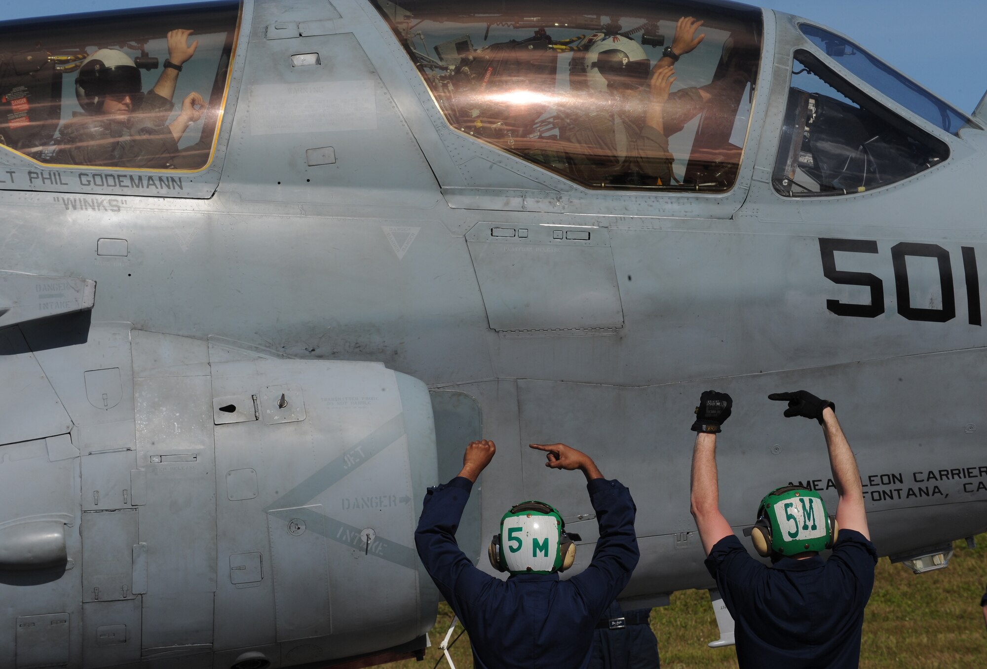 Petty Officer's 3rd Class (left) Timothy Kingery and Roger Sollick both U.S. Navy aviation mates signal to aircrew during a EA-6B Prowler launch, Feb. 3 at Andersen Air Force Base, Guam prior to a local area mission during exercise Cope North 09-1. Navy EA-6B Prowlers from VAQ-136 Carrier Air Wing Five, Atsugi, Japan along with Japan Air Self Defense Force F-2s  from the 6th Squadron, Tsuiki Air Base and E-2Cs from the 601st Squadron, Misawa Air Base will join forward deployed USAF  F-16 Fighting Falcons from the 18th Aggressor Squadron, Eielson Air Force Base, Alaska, B-52 Stratofortress' currently deployed to Andersen AFB, Guam from the 23rd Expeditionary Bomb Squadron will participate in this year's Cope North exercise Feb. 2-13. Cope North 09-1 is the first iteration of a regularly scheduled joint and bilateral exercise and is part of the on-going series of exercises designed to enhance air operations in defense of Japan. 
 
(U.S. Air Force photo/ Master Sgt. Kevin J. Gruenwald) released





















  












 











































  












 

























