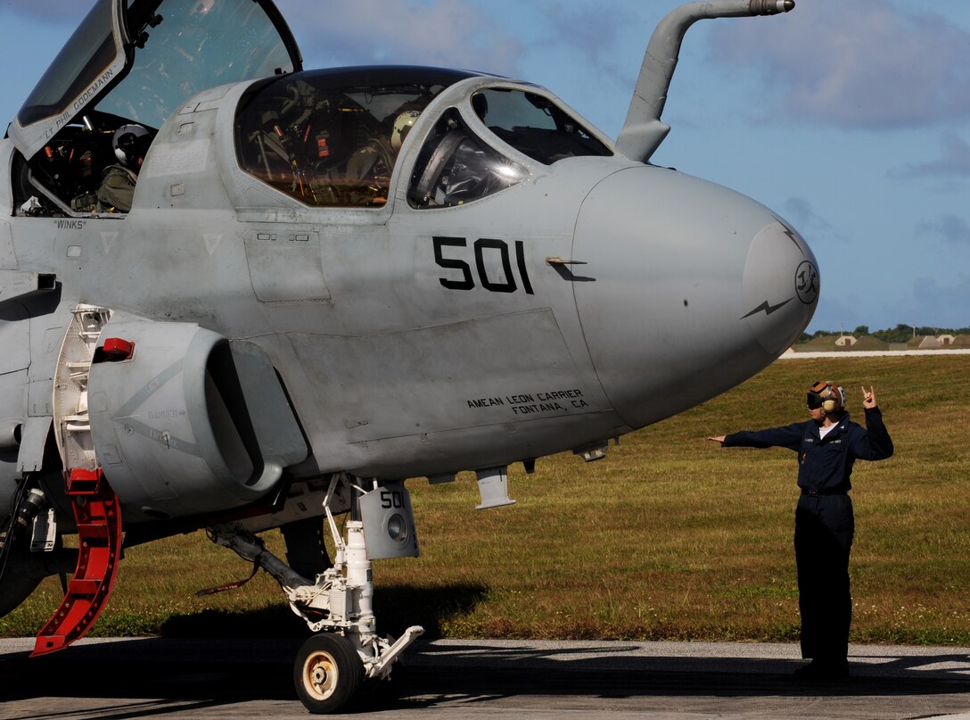 Petty Officer 3rd class Curtis Chambers aviation technician, signals to aircrew during an EA-6B Prowler launch, Feb. 3 at Andersen Air Force Base, Guam prior to a local area mission during exercise Cope North 09-1. Navy EA-6B Prowlers from VAQ-136 Carrier Air Wing Five, Atsugi, Japan along with Japan Air Self Defense Force F-2s  from the 6th Squadron, Tsuiki Air Base and E-2Cs from the 601st Squadron, Misawa Air Base will join forward deployed USAF  F-16 Fighting Falcons from the 18th Aggressor Squadron, Eielson Air Force Base, Alaska, B-52 Stratofortress' currently deployed to Andersen AFB, Guam from the 23rd Expeditionary Bomb Squadron will participate in this year's Cope North exercise Feb. 2-13, with a focus on interoperability. (U.S. Air Force photo/ Master Sgt. Kevin J. Gruenwald) released      