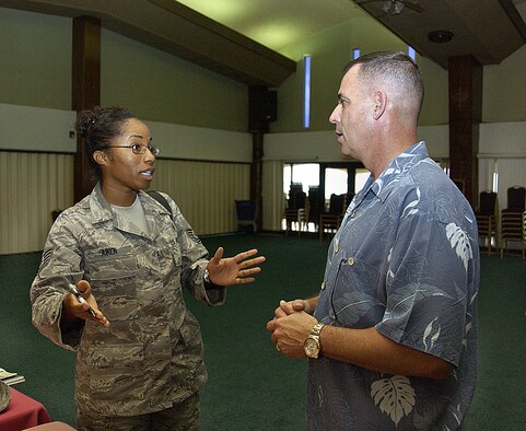 ANDERSEN AIR FORCE BASE, Guam -- Tech. Sgt. Camille Aiken, 36th Medical Operations Squadron dental hygienist, receives financial advice from James Dickie, a United Services Automobile Association military affairs representative, after a financial management seminar here Feb. 3. The seminar focused on investing, insurance debt and budget management. (U.S. Air Force photo by Airman 1st Class Carissa Wolff)                            