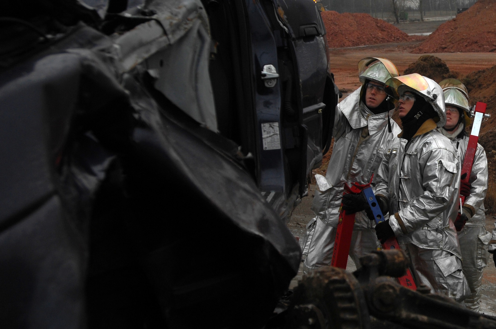 Firefighters from all over U.S. Air Forces in Europe stabilize a car in a simulated mass accident, Jan 27, 2009, at Ramstein Air Base. The firefighters participated in a two-week accident response training course. (U.S. Air Force photo by Airman 1st Class Kenny Holston)