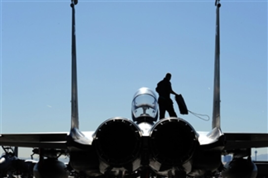 U.S. Air Force Airman 1st Class Joey Cherry, an F-15E Strike Eagle crew chief assigned to the 4th Aircraft Maintenance Unit, Seymour Johnson Air Force Base, N.C., prepares to put intake covers on his jet after a training mission during Exercise Red Flag 09-2 at Nellis Air Force Base, Nev., on Jan. 30, 2009.  Red Flag is a multi-national exercise providing a realistic environment to practice combat scenarios.  