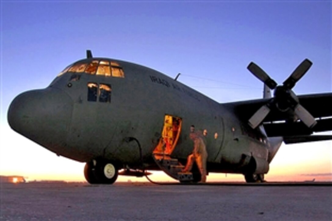 U.S. Air Force Master Sgt. Louis Carter performs a preflight inspection on an Iraqi C-130E on Sather Air Base, Iraq, Feb. 2, 2009, before it leaves to pick up Iraqi election ballot boxes. Carter is assigned to the 321st Air Expeditionary Airlift Squadron.