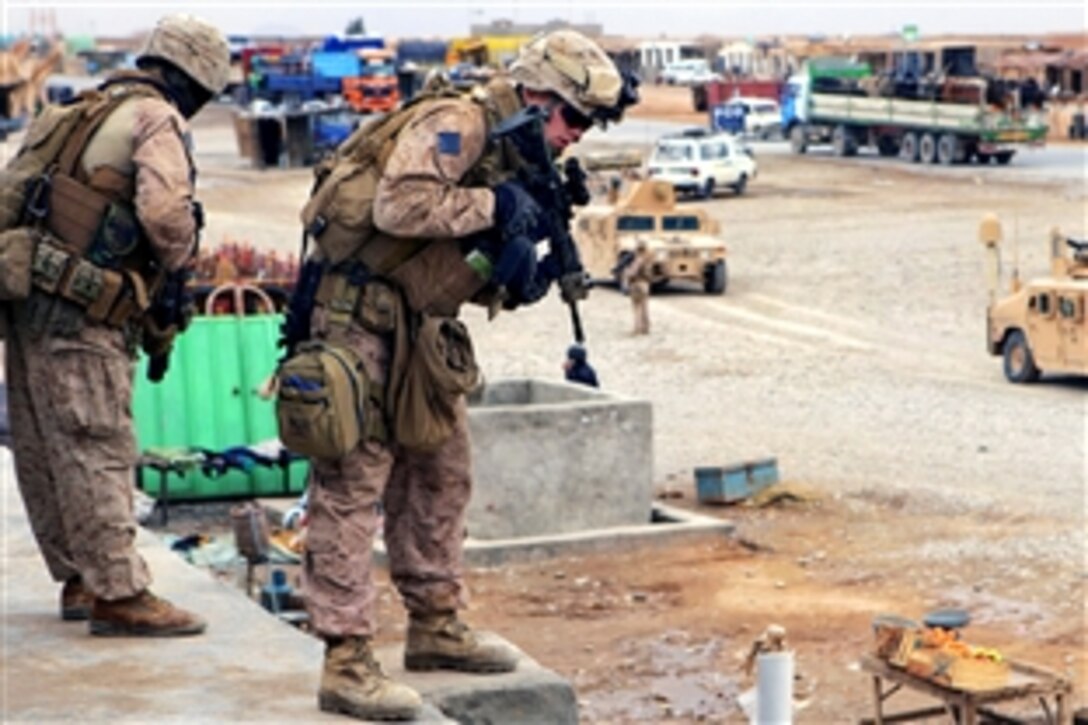 U.S Navy Seaman Apprentice Brian Uibel and U.S. Marine Cpl. Kevin Johnson, left, check stores during a patrol with Afghan national police in Farah province, Afghanistan, Jan. 24, 2009. Uibel and Johnson are assigned to Company K, 3rd Battalion, 8th Marine Regiment.